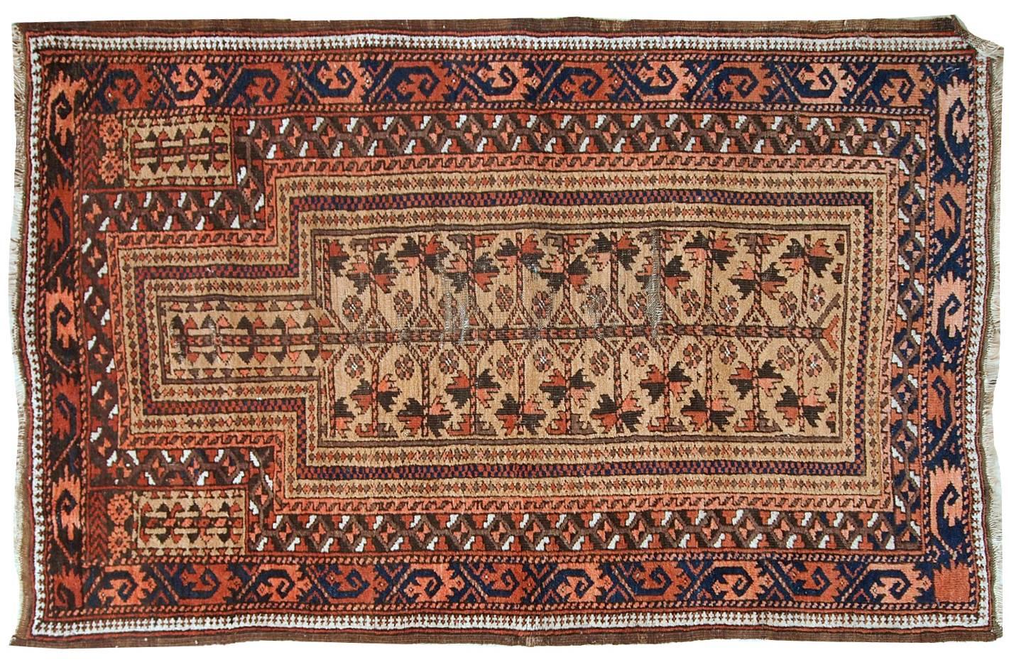 This prayer Baluch rug is in original condition, it has some little age wear and old restoration from the back. Light shade of brown on the field and red decorations. The border has beautiful tribal design in navy blue, pink and red.
 