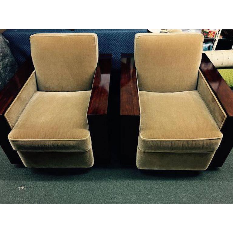 An elegant pair of Club chairs from Ralph Lauren. The Modern Metropolis Silhouette is elegant with simple lines and luxurious materials. The dark, rich finish allows the wood grain to show through, the elite spring down seat cushions are upholstered