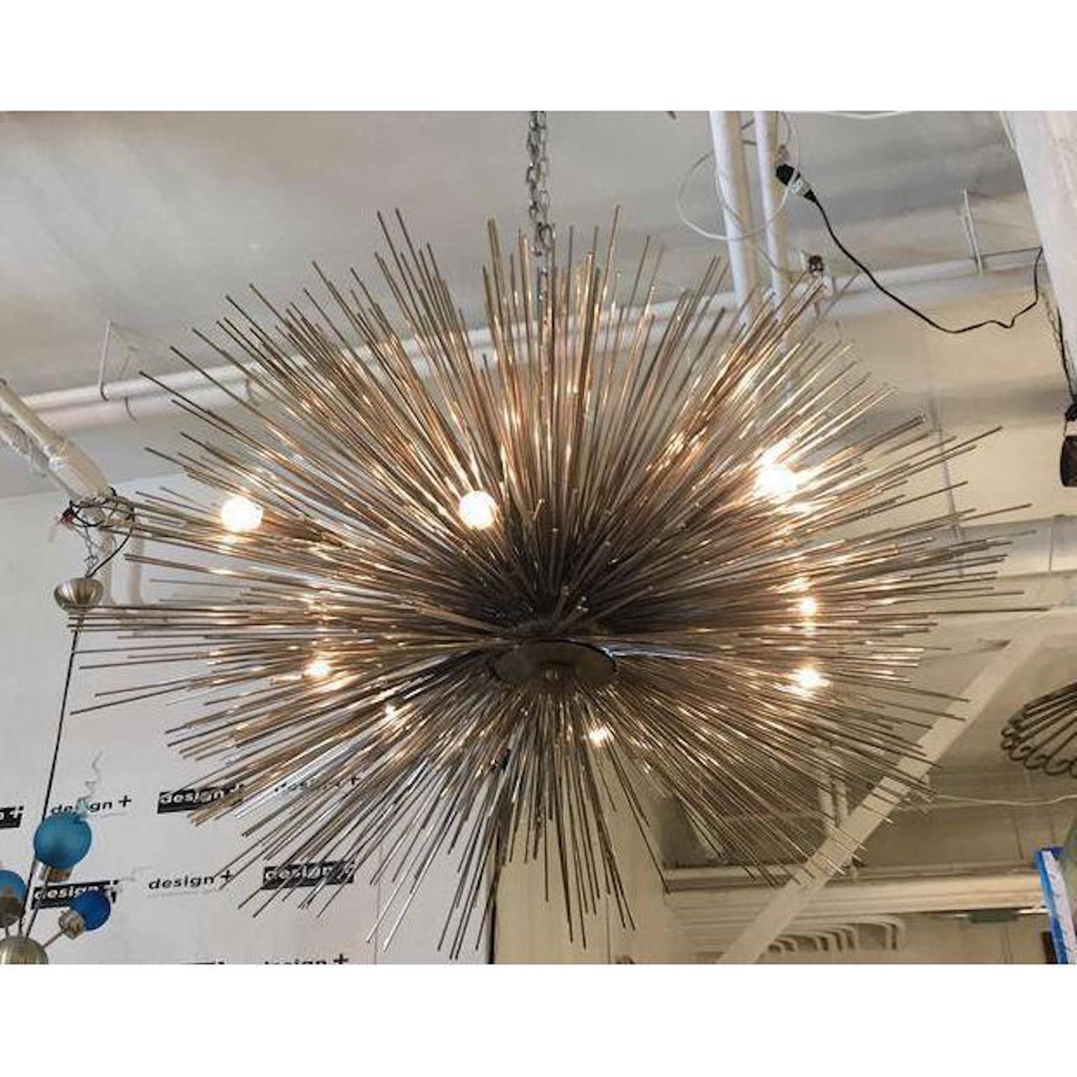 Design Plus Gallery has a eight-light lumière chandelier designed by Jean De Merry. This fixture boasts eight lights and a metallic urchin shape. This piece has a major Mid-Century Modern attitude and would shine in any home bending its design eye