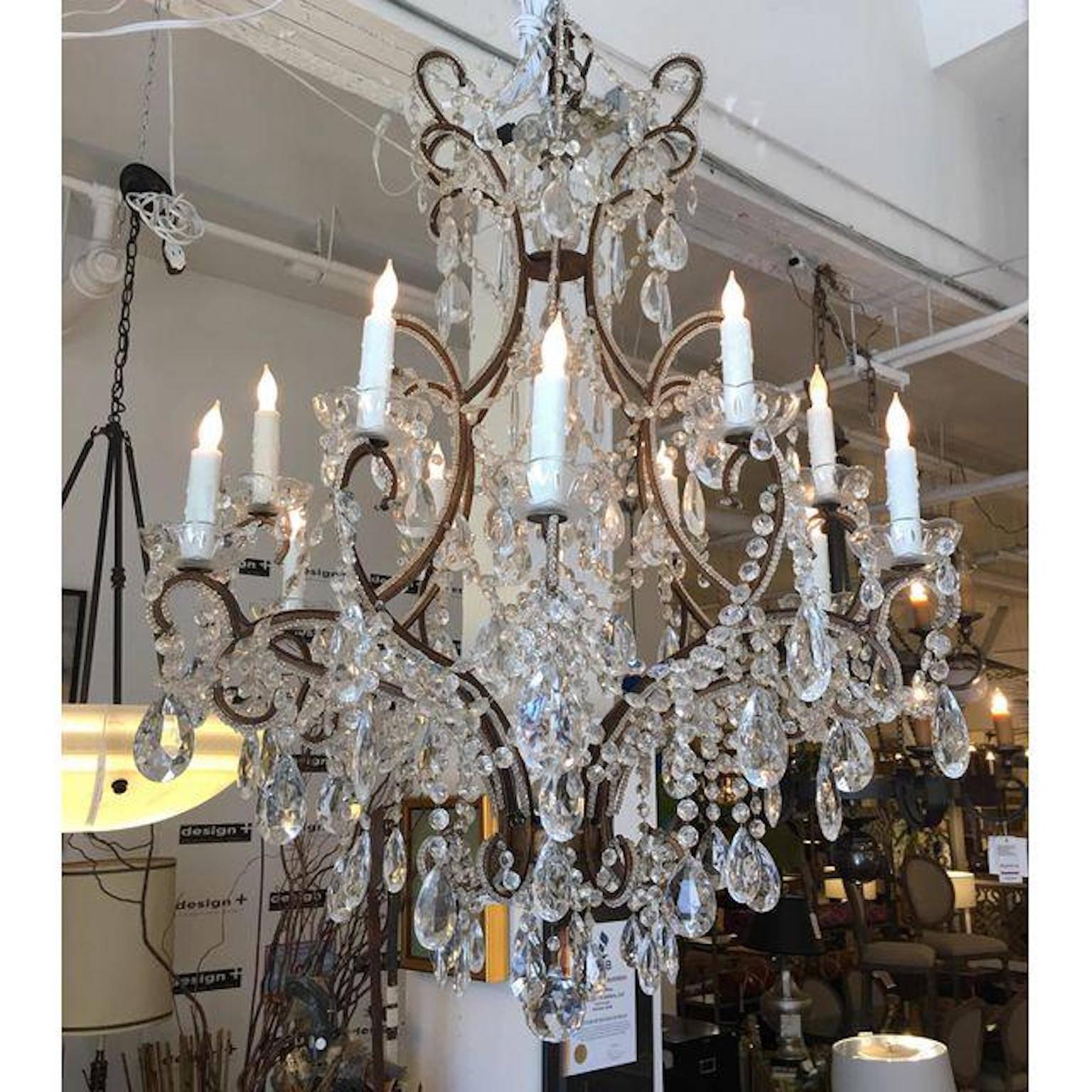 A first quarter Century French Antique beaded Chandelier, gilded and brass twelve-light chandelier in the Louis XV Style, profusely with cut beaded chains, faceted drops in four sizes facet cut spears, the frame outlined in glass bead chains through