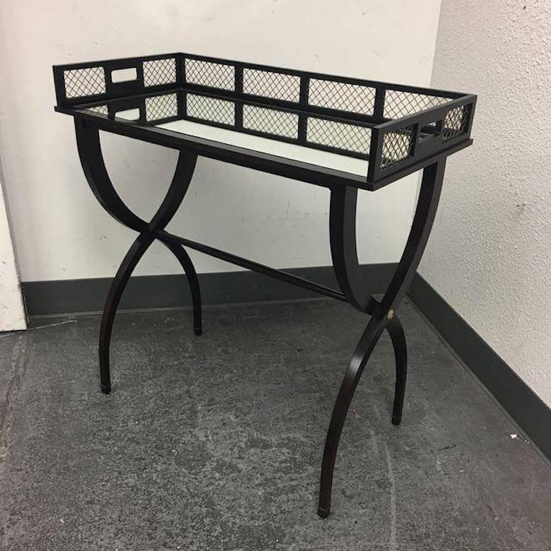 Design Plus Gallery has a fabulous drinks tray table by Baker Furniture. Designed by Barbara Barry. Created in a rich ebony finish with an antique brass gallery and delicate arching legs, this drinks tray is both functional and aesthetically