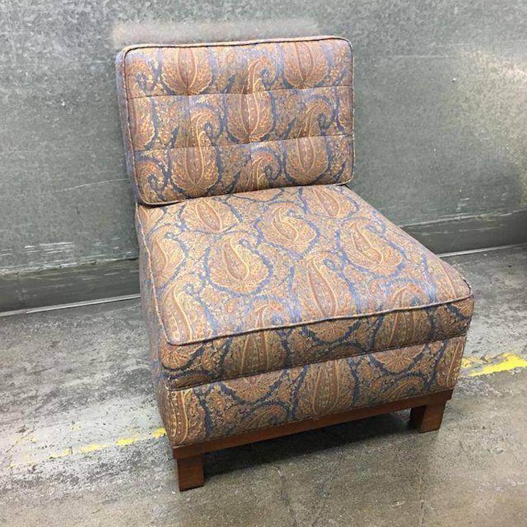 A Penelope slipper chair by Pearson. Since 1941, Pearson has been producing bespoke furnishings for a demanding clientele. Consisting of an upholstery of blue and red paisley, this stunning chair will make a statement in any room that its located