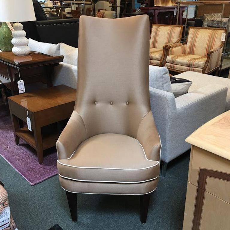 A elegant accent chair from Jonathan Adler's first furniture collection. The Prescott sports satin weave "Silkworm" fabric in bark with natural welt and subtle tufting. Finished with tapered espresso legs. Measure: Arm height 22",