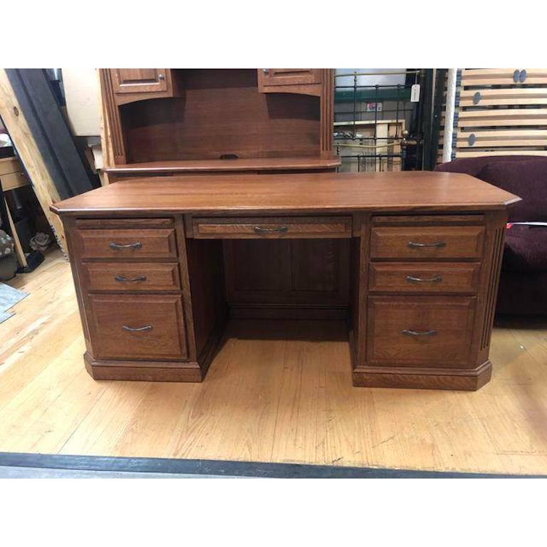 A solid quarter sawn oak executive desk. This beautiful piece was made here in the US by the Amish. It has been meticulously constructed with subtle details that add to its stately demeanor. This desk provides lots of storage and organizational
