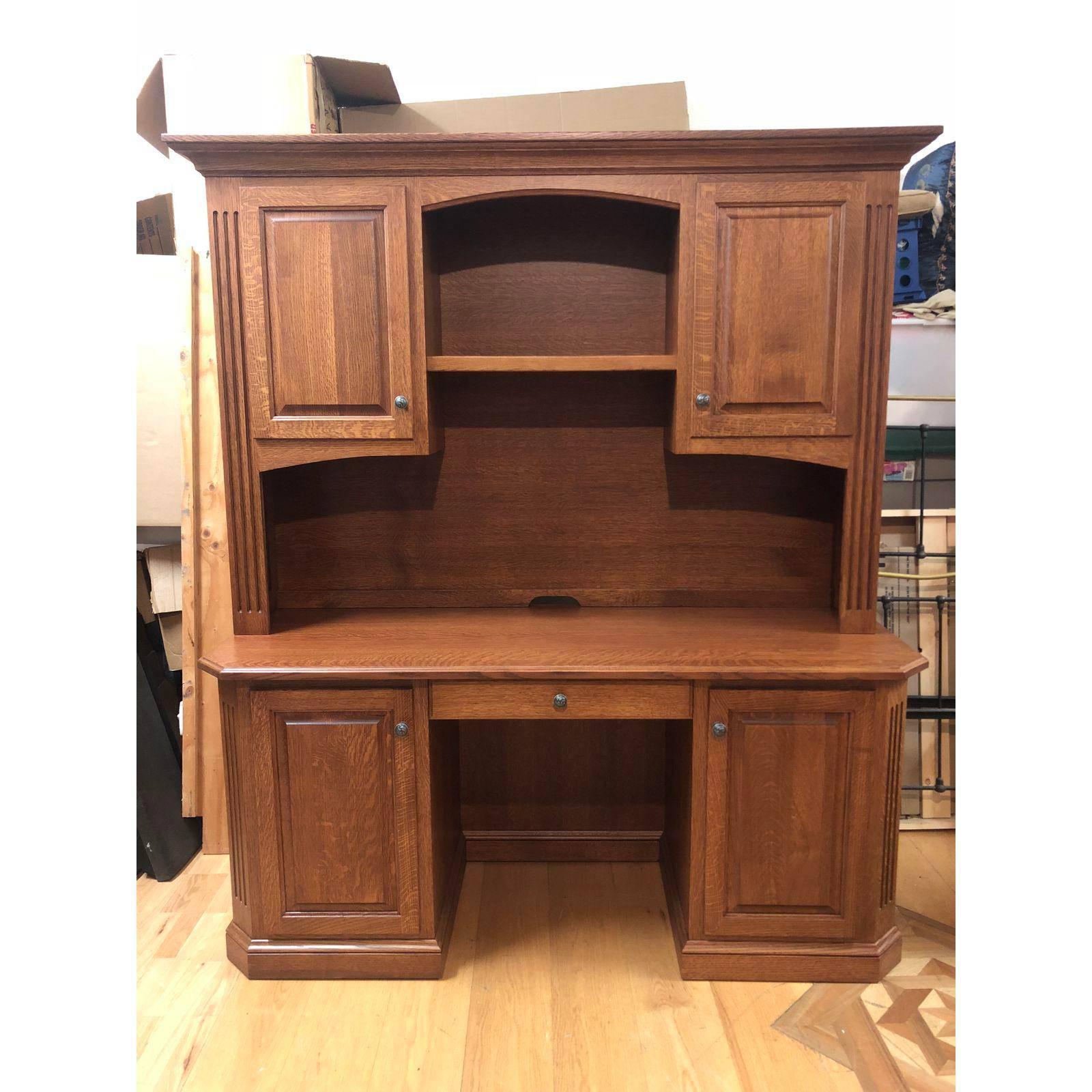 An Amish made, solid oak credenza with a solid oak hutch. The two pieces were constructed using quarter sawn oak. It was meticulously built with lots of subtle detailing which all add to its stately demeanor. This set offers ample storage for all