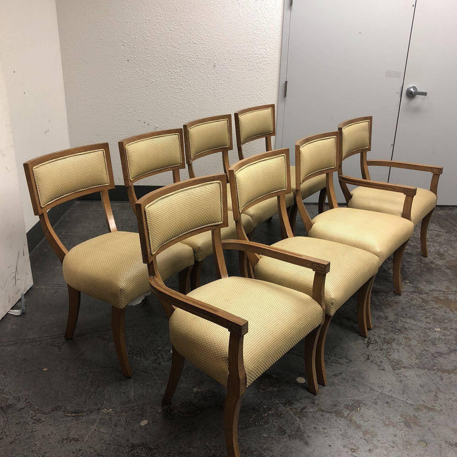 A beautiful set by Michael Berman Limited. Eight gorgeous grand Klismos dining chairs which consist of two with arms and six no armchairs. The upholstery is a woven wheat leather. The wood finish is a cirused oak. 

"Michael Berman limited and