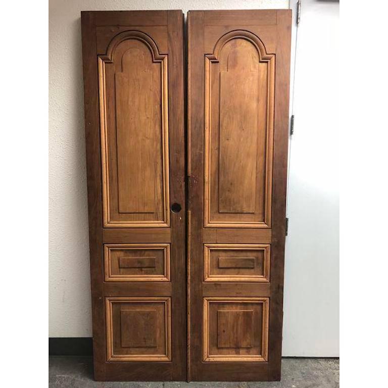 A one of a kind pair of doors. The doors were hand carved for La Casa Zaldivar - Pacheco in El Salvador in or circa 1906. The doors were only allowed to leave the country after the mass destruction from the earth quake in 2000. These doors truly are
