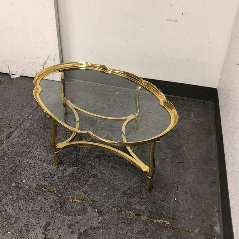 A La Barge hand cast solid brass oval coffee table. A piecrust trim and insert glass top. This stunner has a a very unique shape which gives it loads of character. 


 