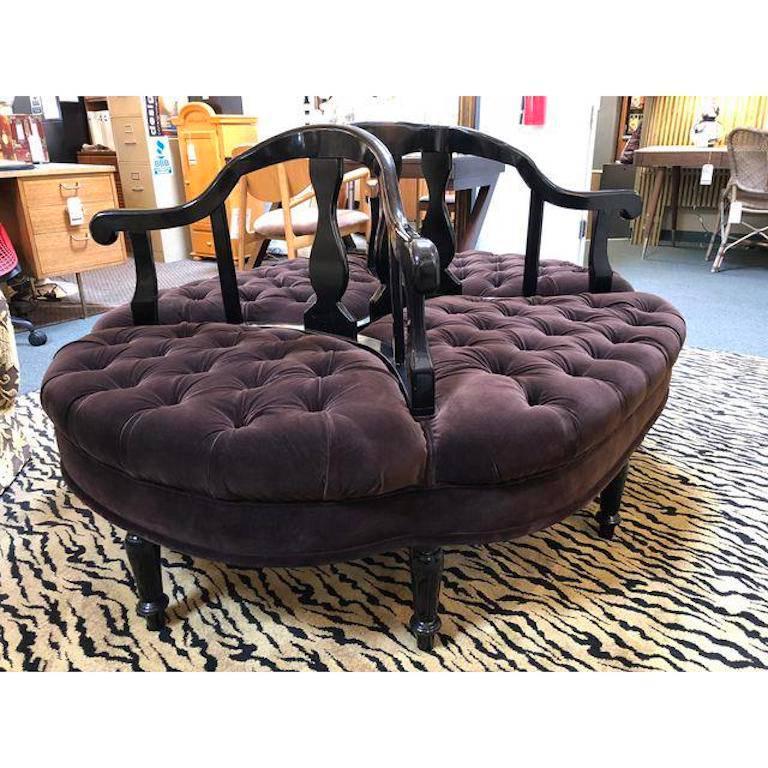 A Paris flea market find. Carved lacquered wood embraces deeply tufted brown velvet seating that allows whispers over one's shoulders, or a place to peruse one's closet. Unique and elegant oval chaise.
 