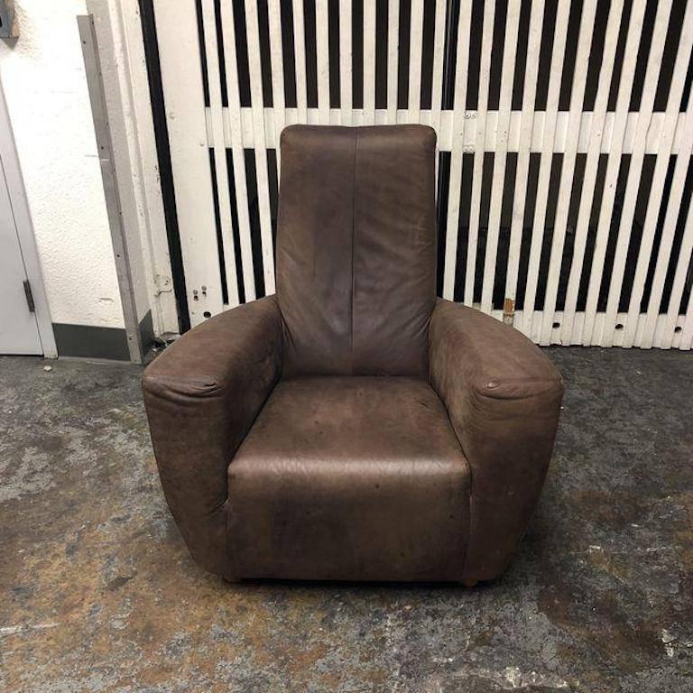 A Gerard Van Den Berg longa chair. This Contemporary Dutch design chair is upholstered in a Chocolate Brown distressed Leather. The chairs has a cozy, lived on sensibility. Designed for label, The Netherlands. Measures: Seat height 15 inches, arm