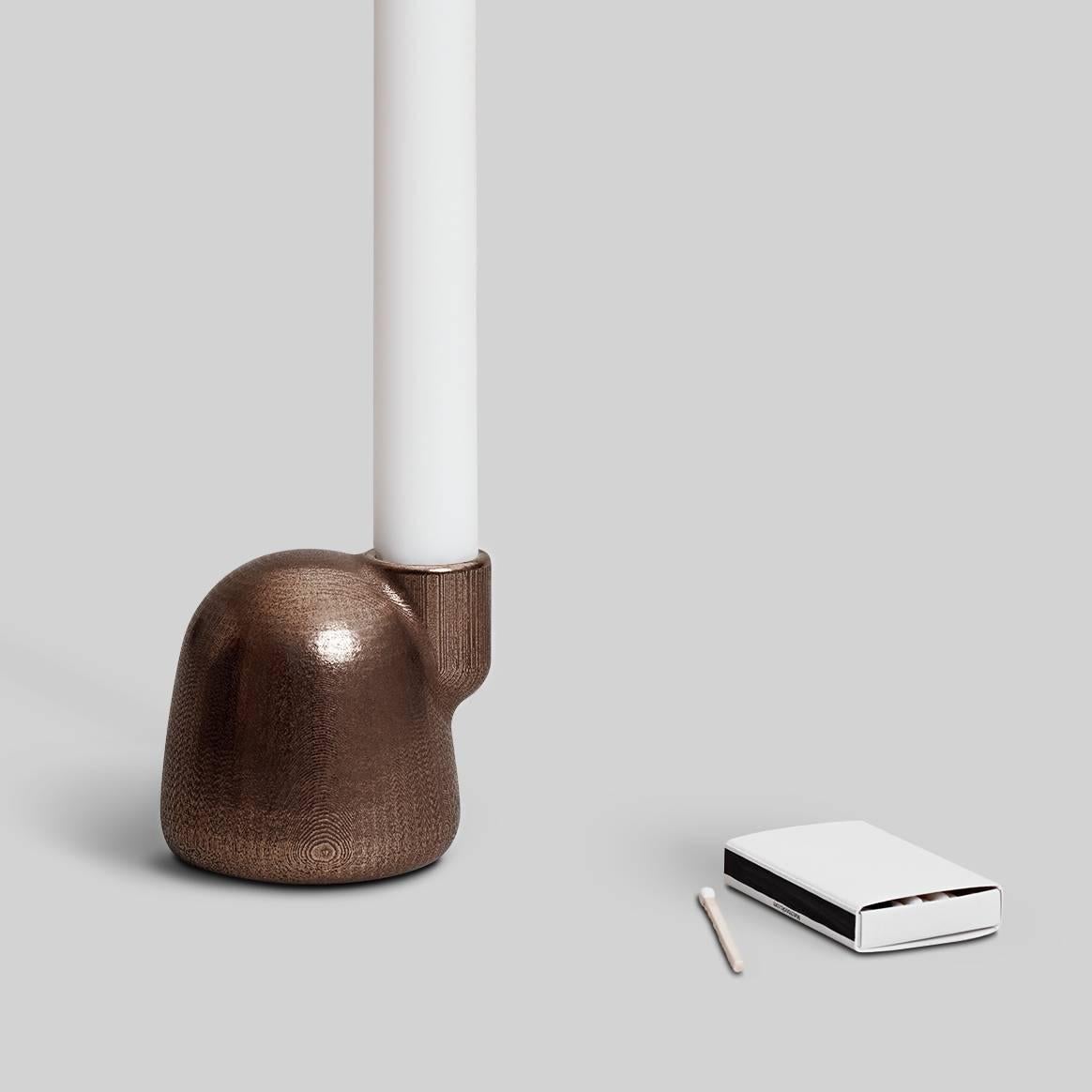The EE Candleholder tells its own origin story. Inspired by the way that growth is expressed in nature, the candleholder's layers of digitally printed grain act like the rings in trees or layers of rock: they reflect the process required to create