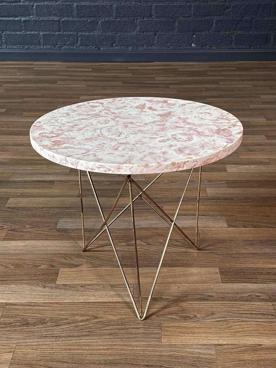 Condition: Original Vintage Condition
Materials: Pink Marble Stone, Patinated Brass

This sculptural side table by Martin Perfit for Rene Brancusi, crafted in Italy during the 1960s, exemplifies the refined elegance of mid-century modern design. The