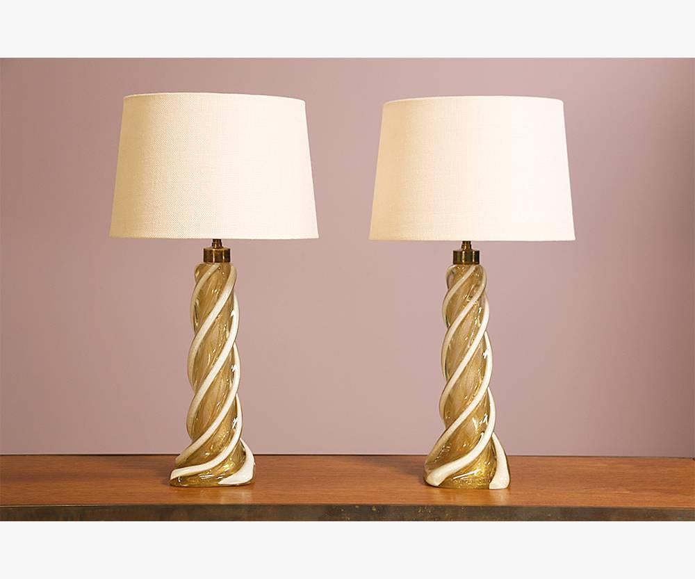 Spectacular pair of 1960s Murano glass lamps executed in a beautiful pattern consisting of white and gold flecked swirls by Seguso, Italy. Nice heavy construction. Both lamps are in excellent condition with no chips or cracks. Original wiring is in