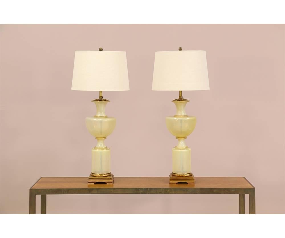 A gorgeous pair of 1960s Italian gold flecked opalescent Murano glass lamps with detailed brass hardware. Imported by the Marbro Lamp Company, Los Angeles.  These impressive lamps would add a sense of sophistication to any fine interior. Wired and