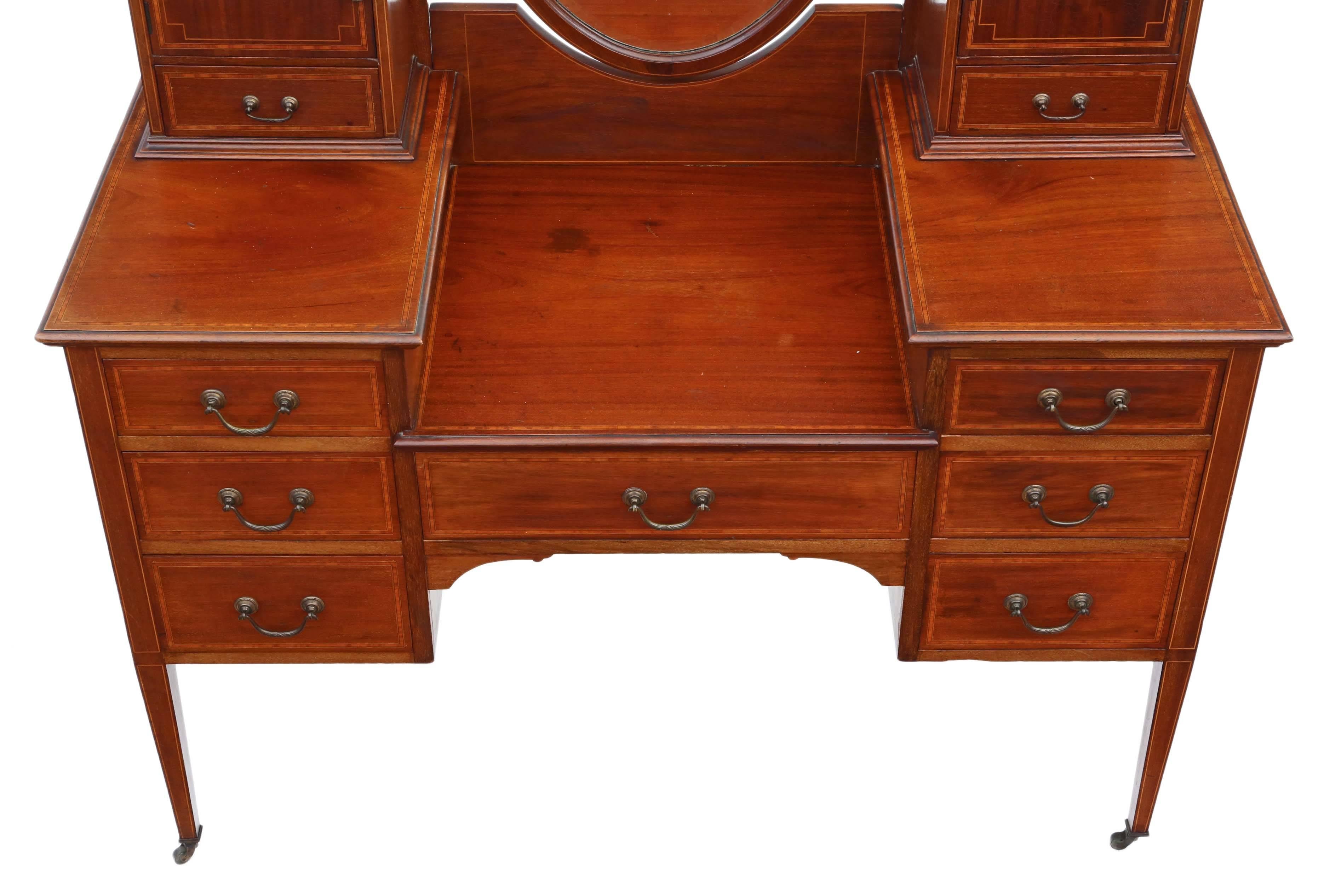 Antique quality large Edwardian inlaid mahogany dressing table.

This is a lovely quality item, that is full of age, charm and character.

Solid with no loose joints and no woodworm.

The drawers slide freely. Period brass castors (with some wear as