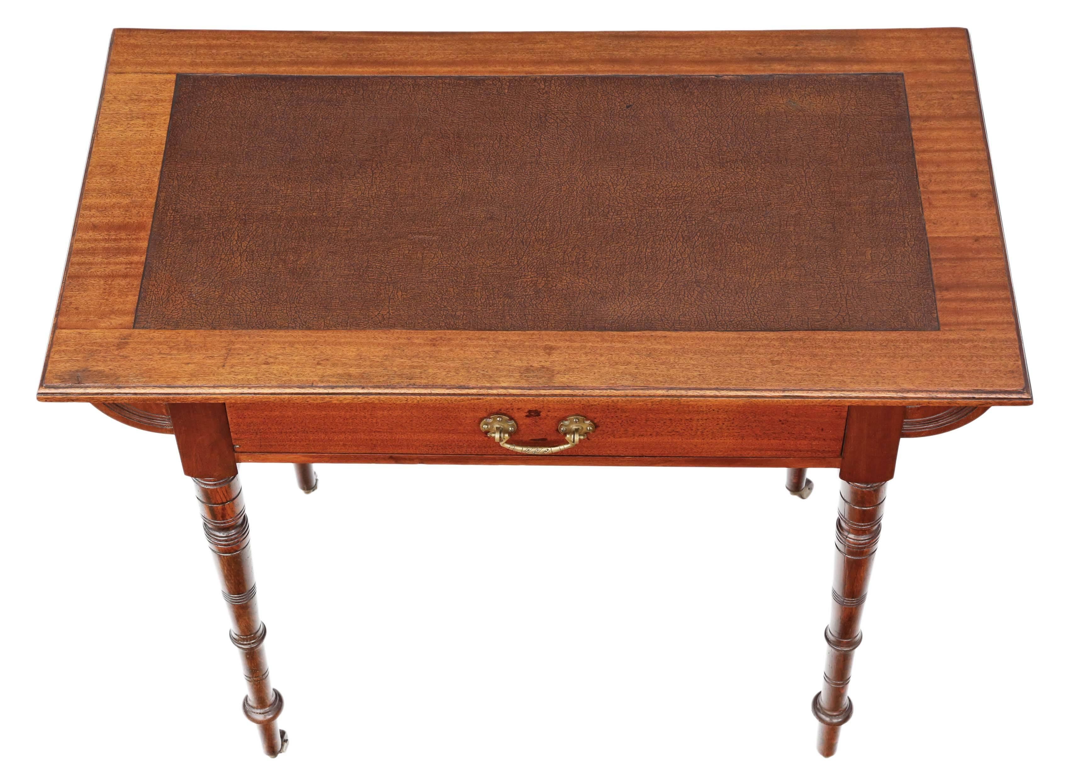 Antique late Victorian circa 1900 mahogany desk or writing table. Simple elegant style. 

No loose joints. Full of age, character and charm. The mahogany lined drawer slides freely. Period brass and ceramic castors. Patinated old rexine writing