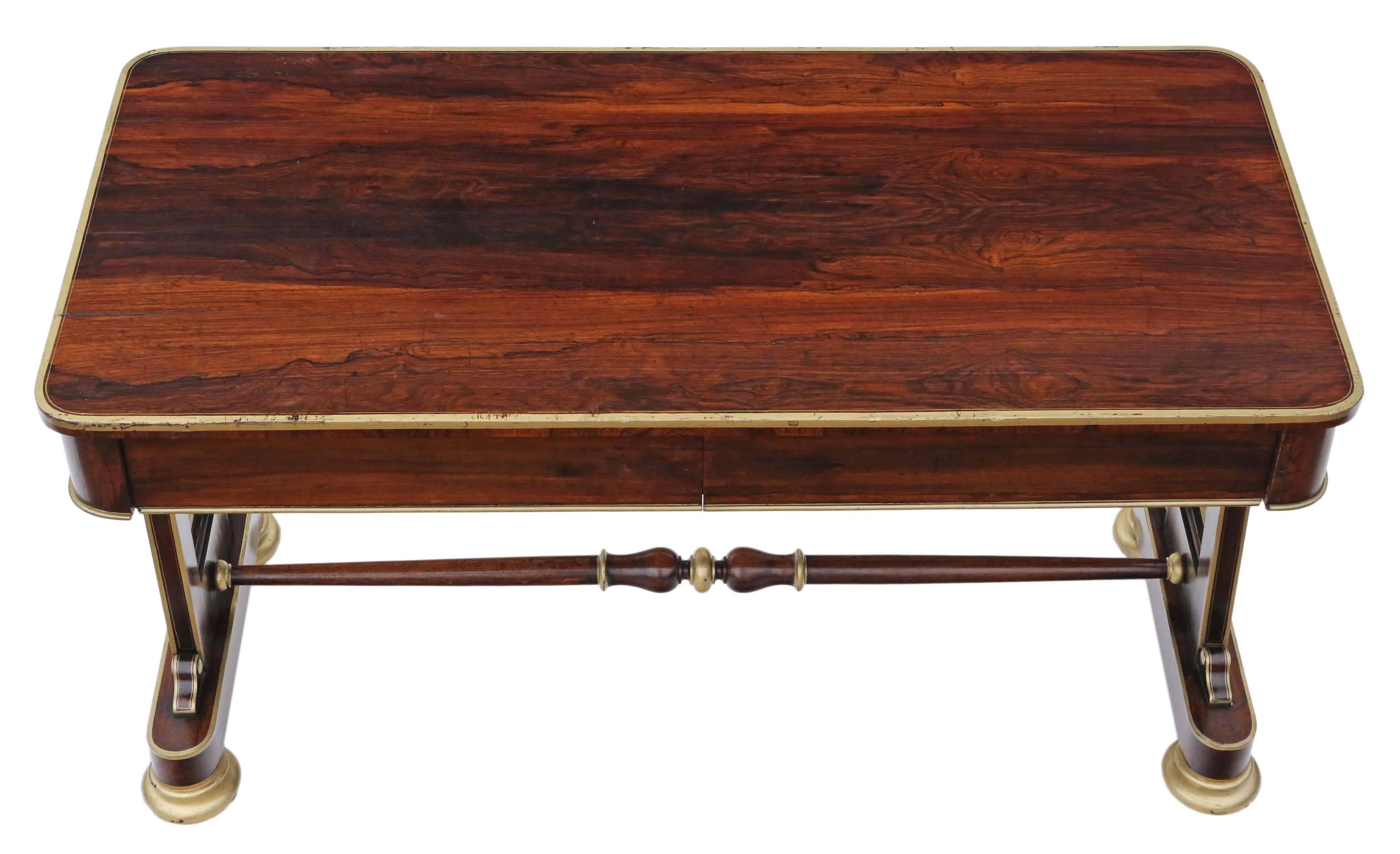 Antique quality Regency circa 1825 rosewood library desk writing table. Two blind oak lined drawers to one side, which slide freely.

Solid and strong, with no loose joints. Full of age, character and charm. Attractive stretcher base with period