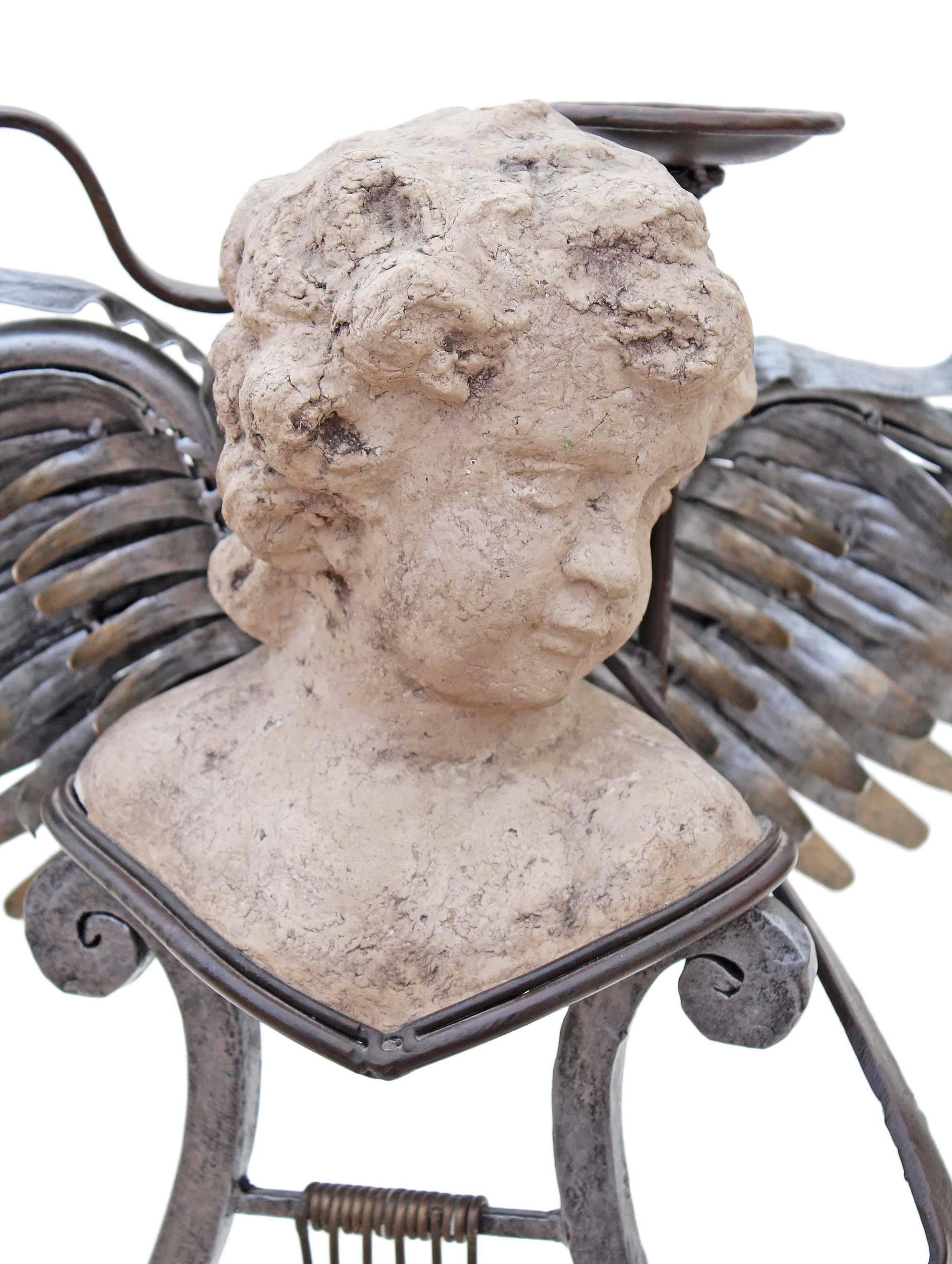 Antique large mixed metal and stucco contemporary 'Angel' statue work of art or candelabra.

We are unsure of the exact age (artist unknown), but suspect that it was constructed in the last 20 years.

A lot of work went into this piece, which