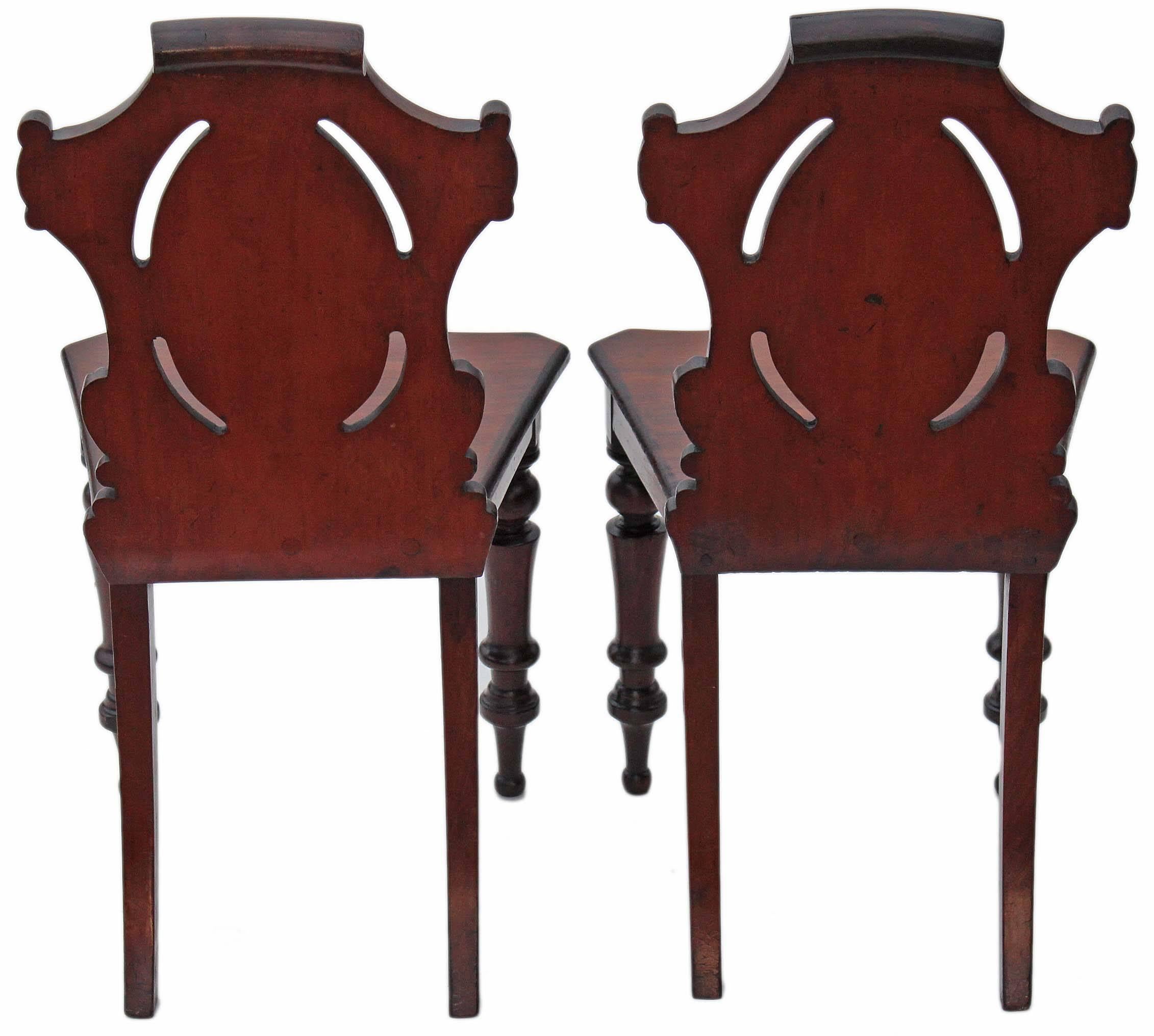 Antique pair of 19th century Victorian carved mahogany hall chairs.

High quality, heavy, attractive chairs, with no loose joints or wobbles.

Full of age, character and charm.

Compact proportions, traditional form and quality