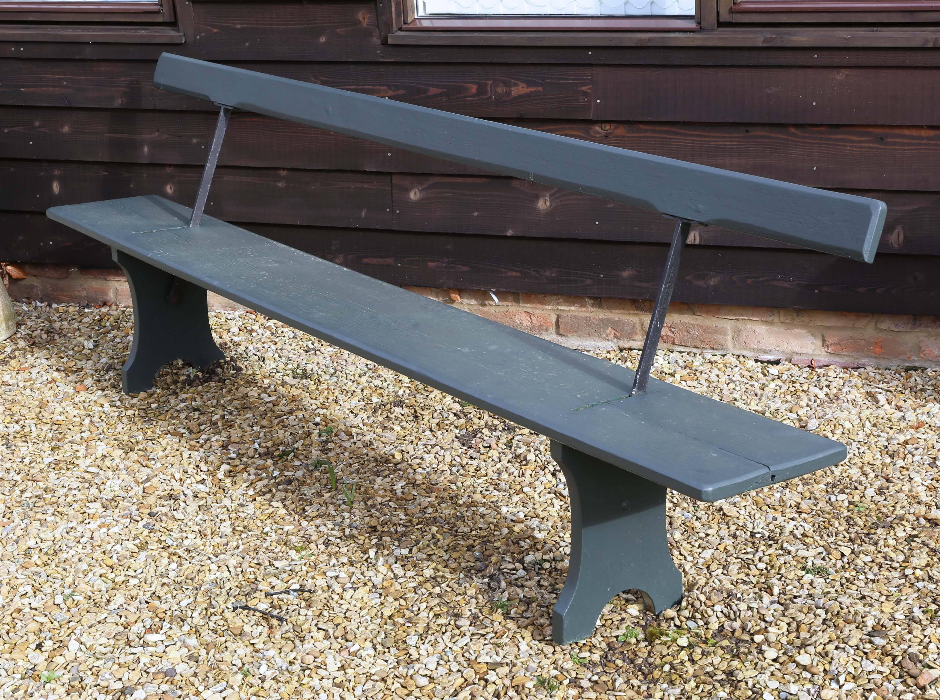Large antique 9' double-sided railway platform bench.
We believe that the bench is around 60 years old, most likely pitch pine (although it is hard to tell under paint).

Painted in F&B green smoke. No rot.

Very large, heavy and impressive
