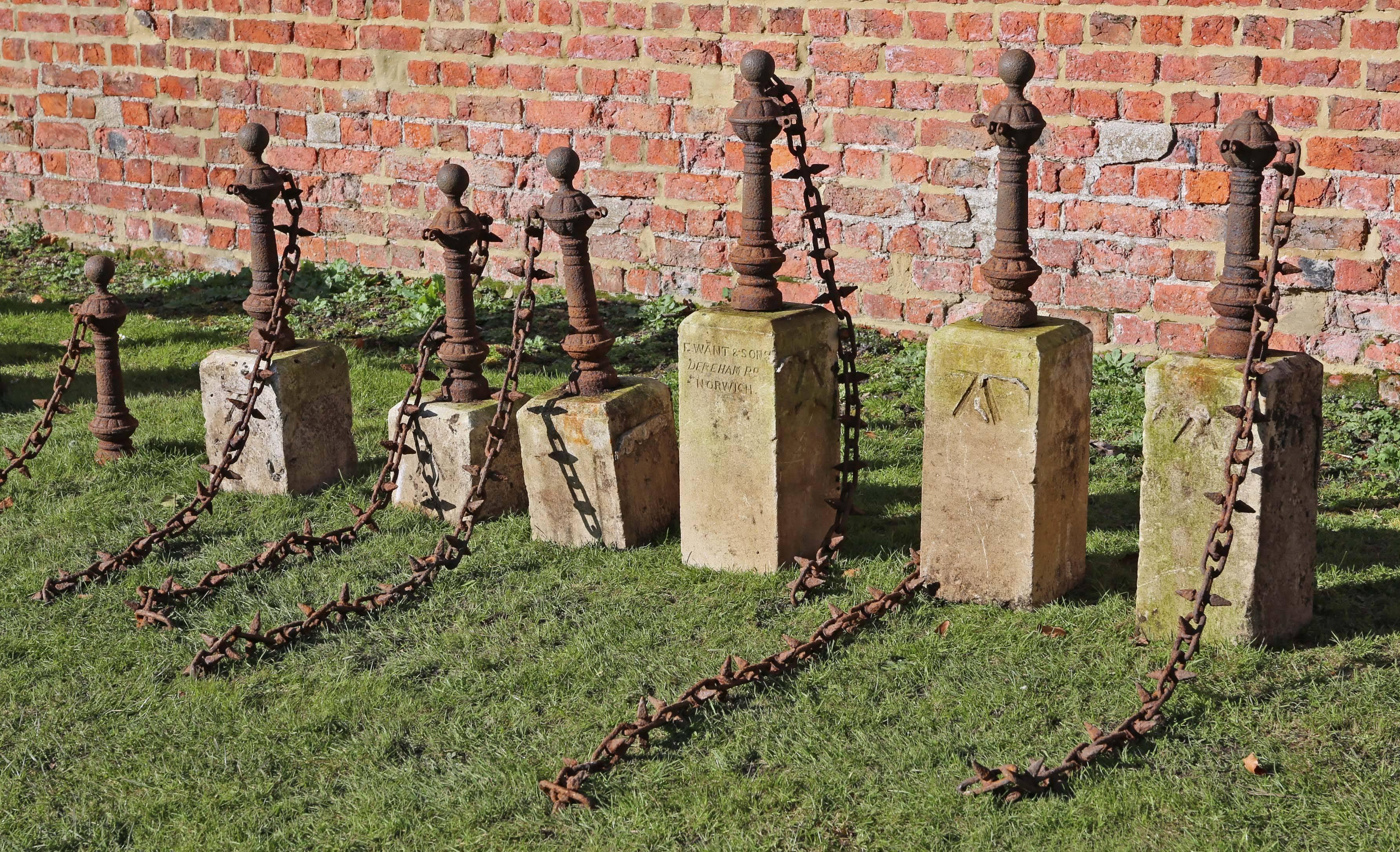 Antique set of seven cast iron bollards with chain and stone bases. Would make great lawn or driveway edging. Around 100 years old.

We have seven bollards (six with stone bases of differing sizes and one without). A little work needed to weld an