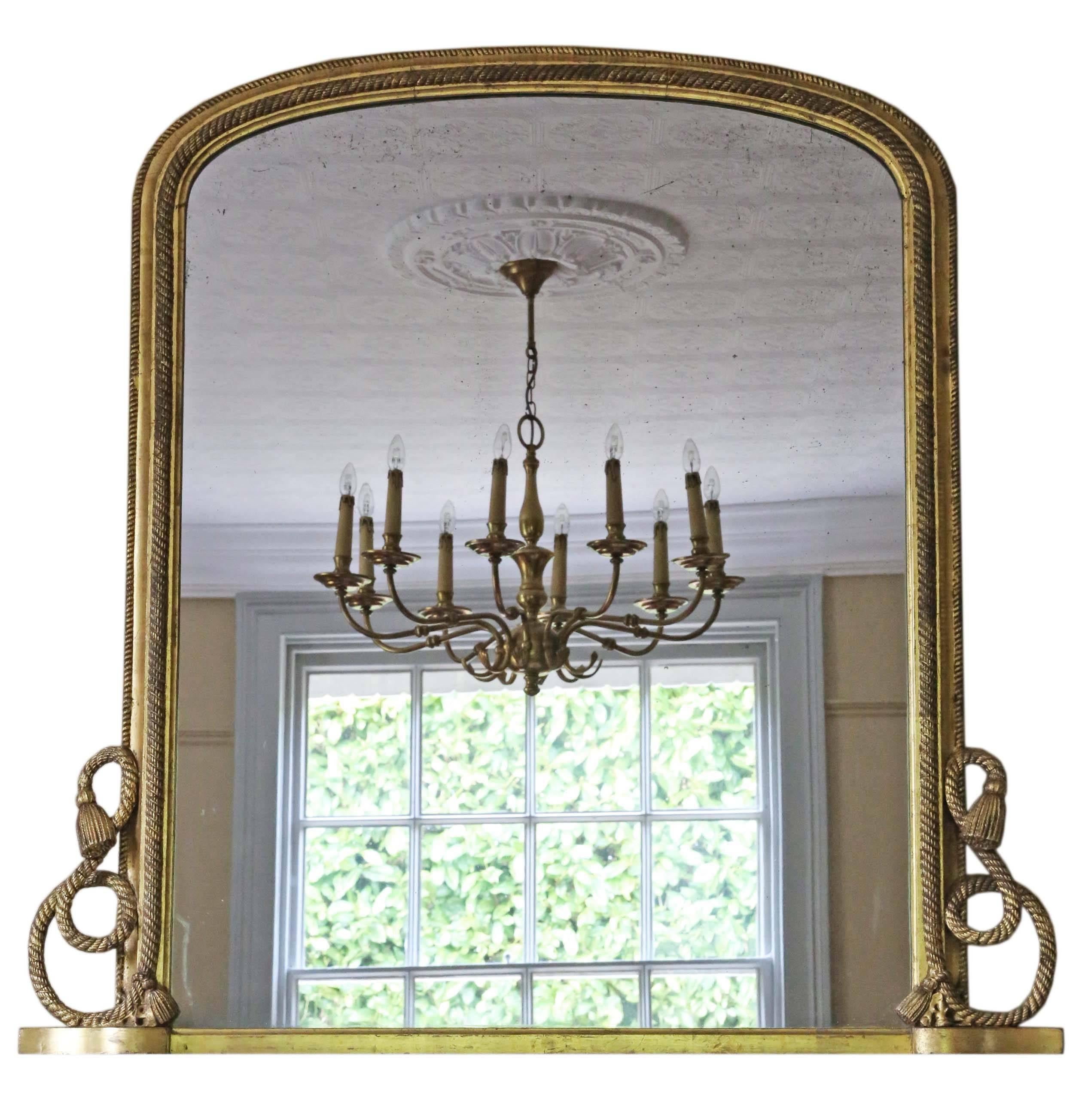Antique large Victorian gilt wall mirror overmantle circa 1870. Lovely patinated frame, genuine gilding with no major losses.

This is a lovely mirror, that is full of age, charm and character no woodworm.

An impressive and opulent rare find,