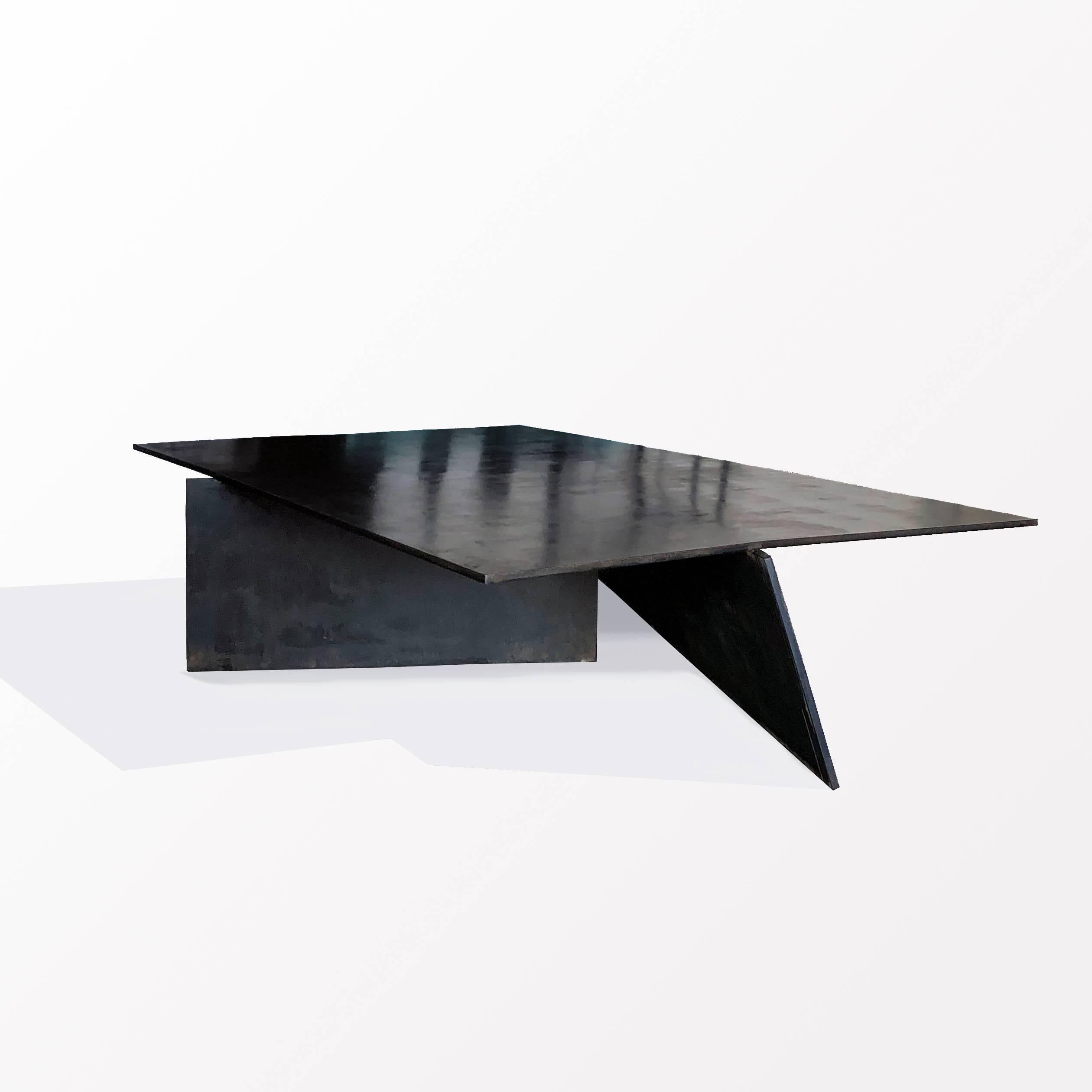 TABLE NO. 10 
J.M. Szymanski
d. 2018

This table is handmade from ½” thick, blackened, and waxed steel. The three individual flat planes are combined, creating a dynamic and minimalistic look, crafted to our clients’ specific needs and