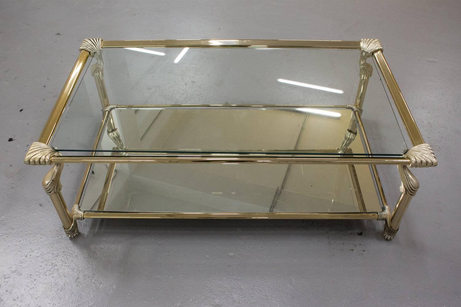 Spanish-designed Muebles Curvasa coffee table with a brass frame and glass and mirror inlay. The table is signed on each corner. Presumably the table dates back from the 1970s. The legs of the table feature detailed carvings, which gives the table a