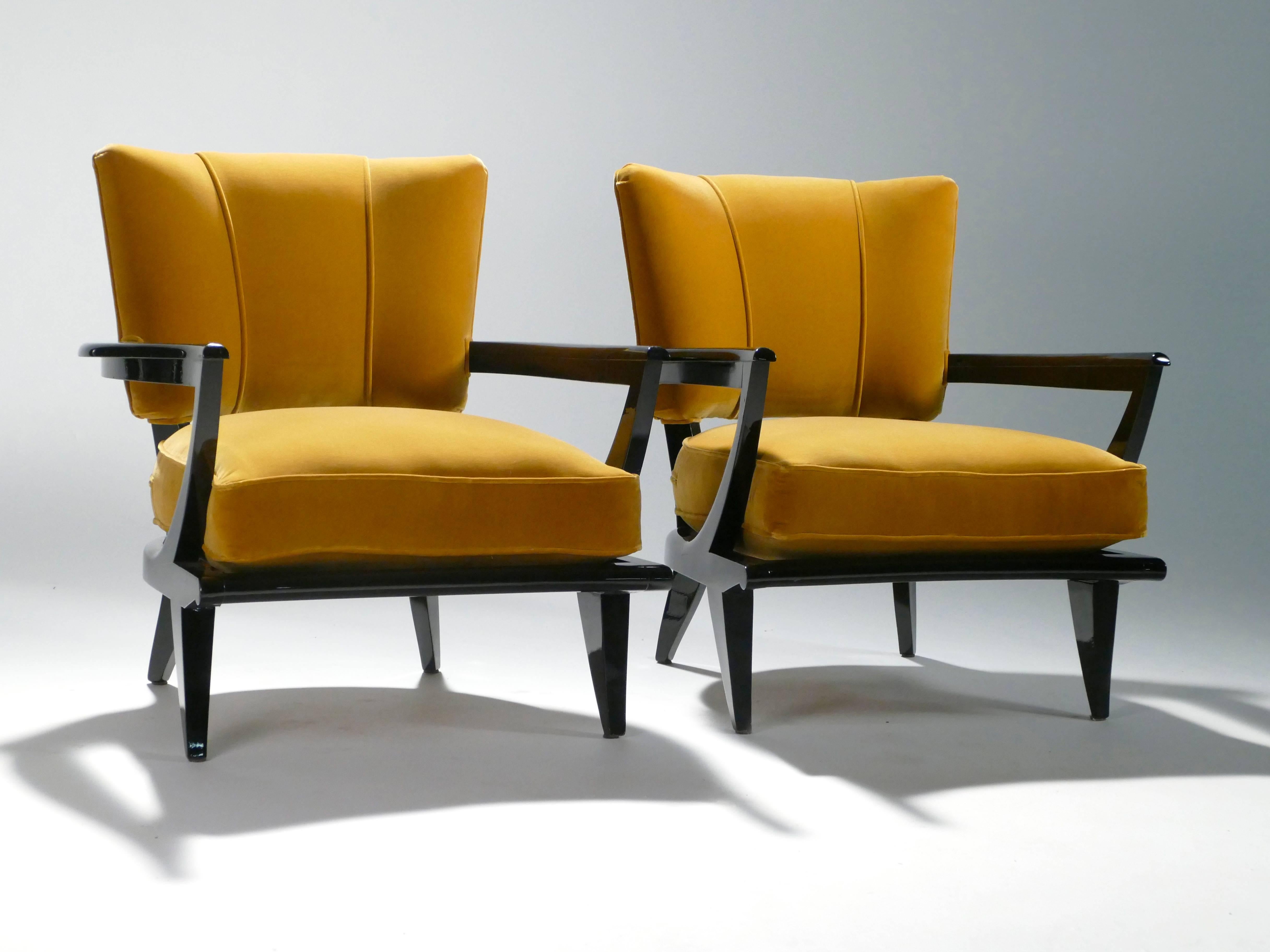 These twin armchairs have been recently reupholstered with fabric by Osborne & Little: Mikado Velvet in a trendy ocher color that complements the original rich black wood. The smart contrast between the supple fabric chair backs and lustrous wood