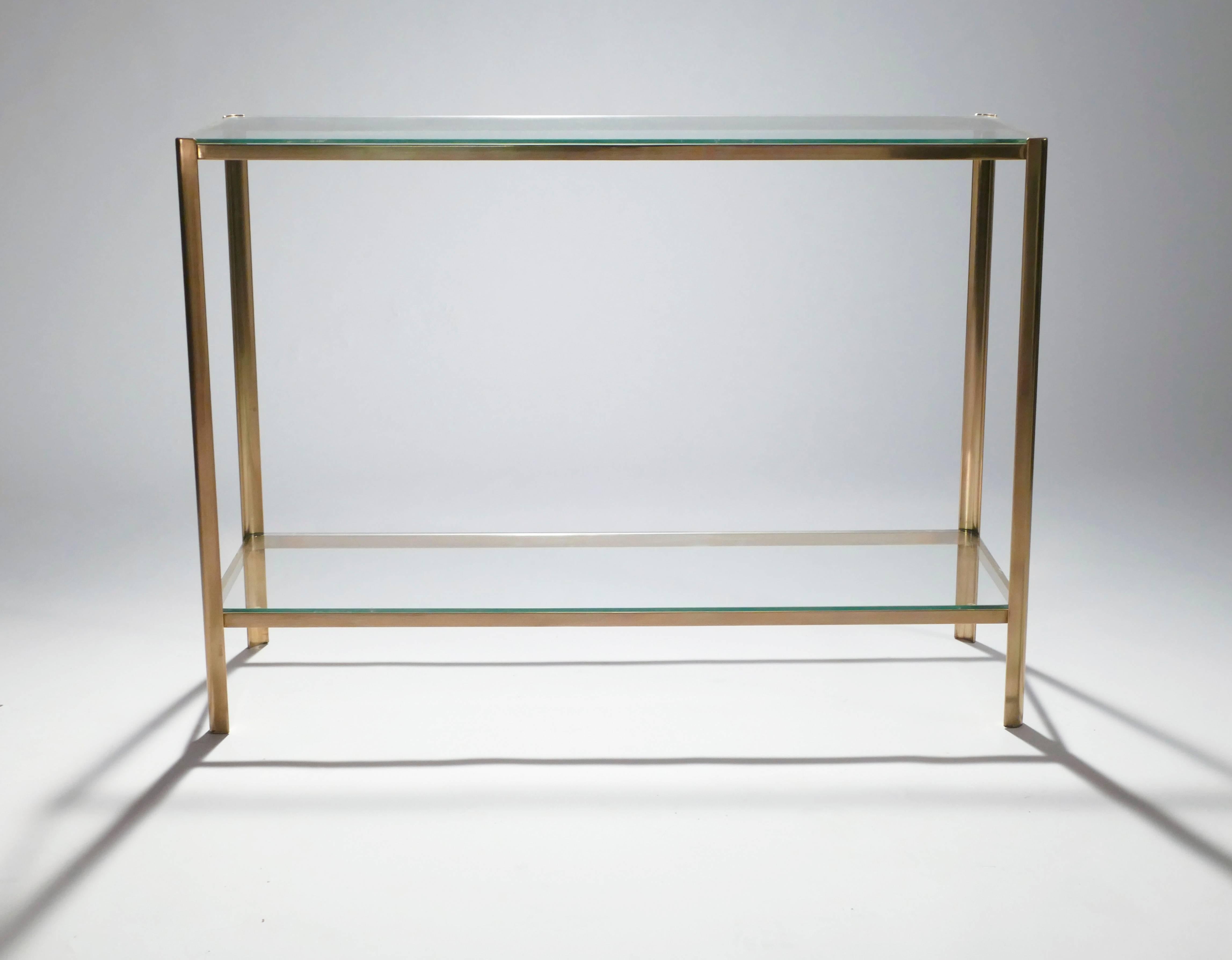 This mint-condition piece is signed by Jacques Quinet and stamped by Broncz. A rare find as a console table, it’s nonetheless quintessentially midcentury. Its solid brass feet and pristine glass 2/3 top present the simple, timeless look of the era.