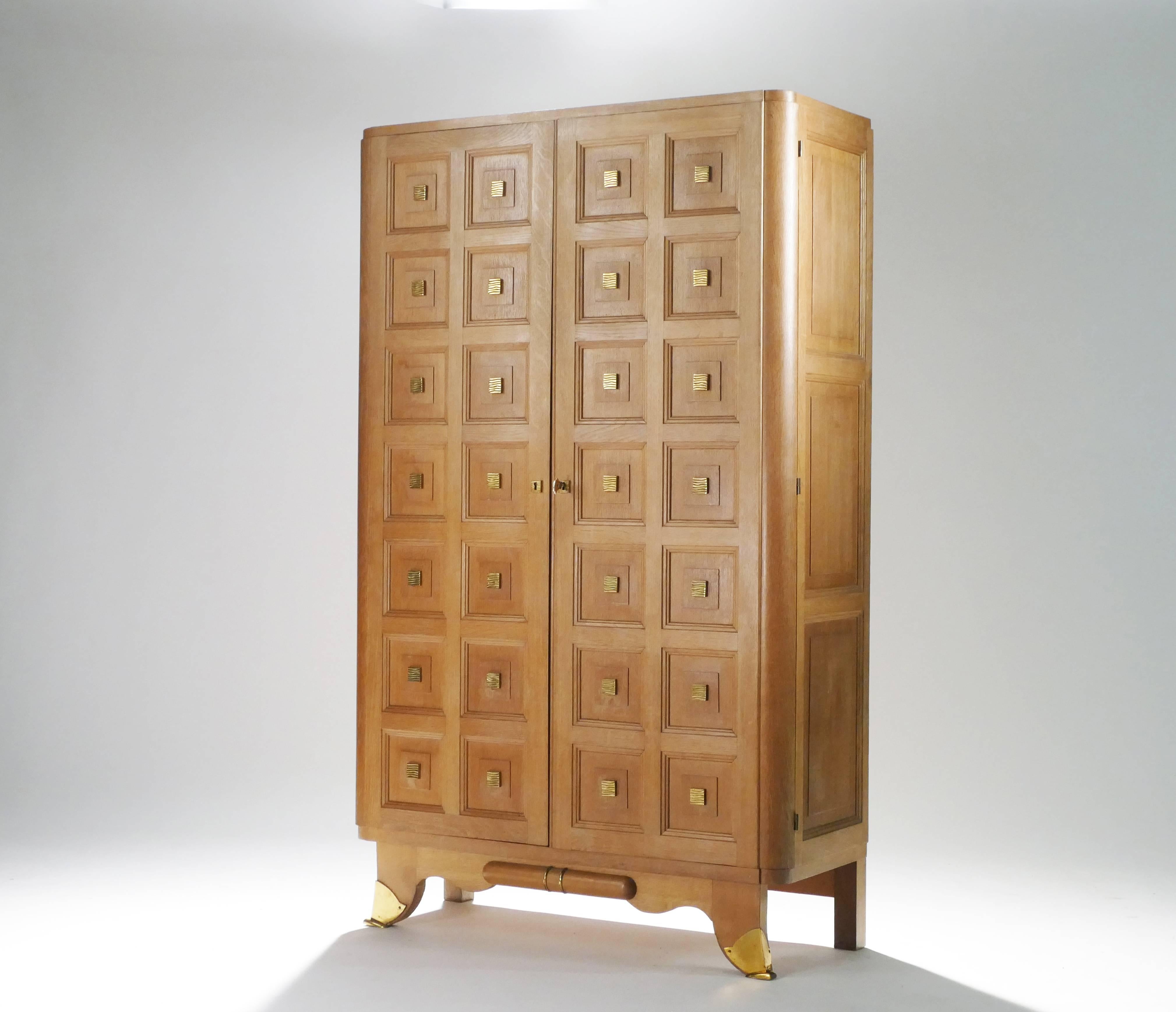 Spacious shelves make this large oak cabinet suitable as a bedroom wardrobe or as a multipurpose and decorative cabinet in an entryway or living room. The cabin doors and feet are adorned with quality bronze, and the inner shelves feature original