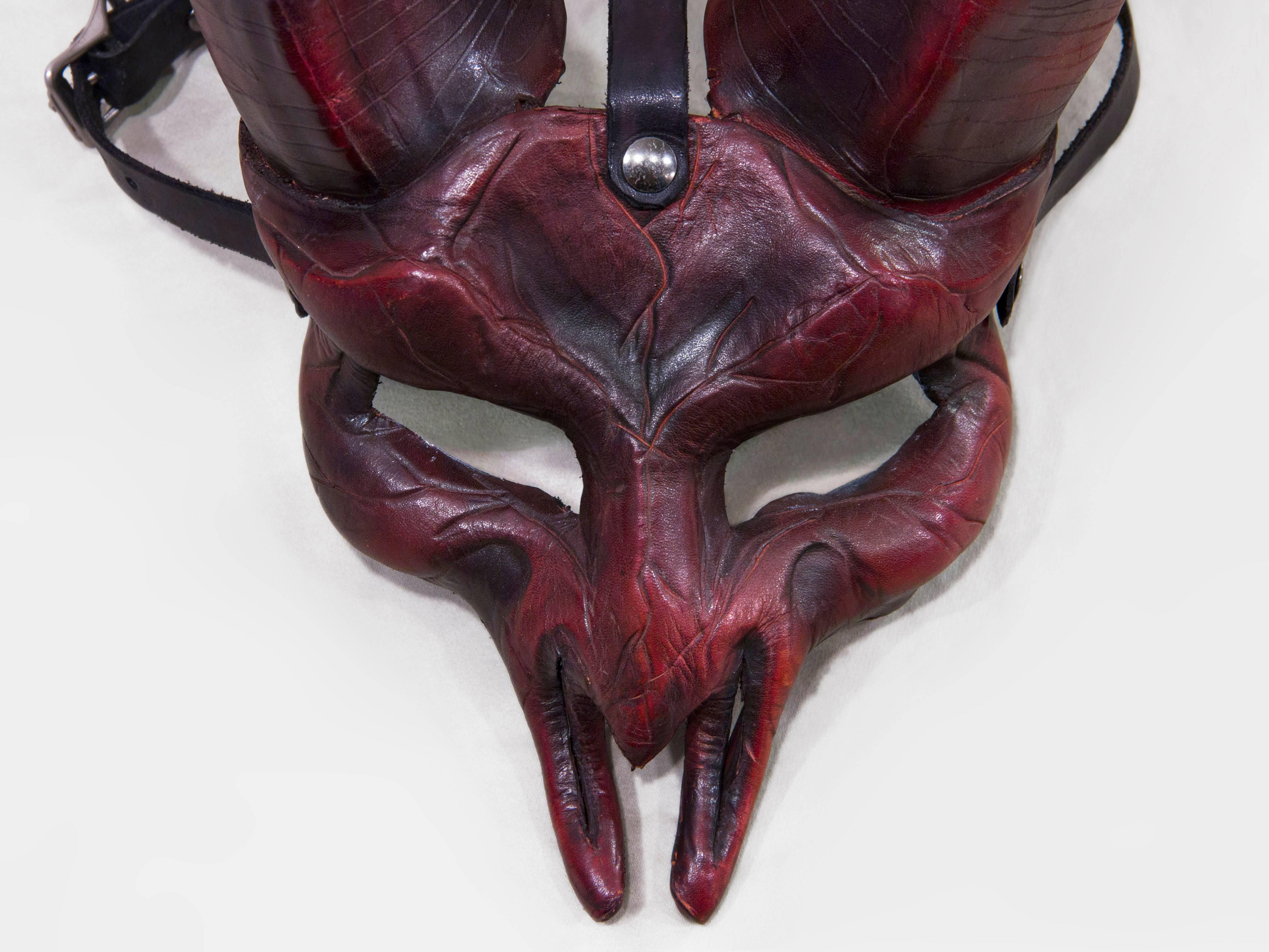 Inspired by the Ram, the symbol of Aries. Dark reds and blacks drape this deliciously sinister Silhouette. This piece is wearable art, making it perfect for a masquerade, costume party, Halloween, or as a beautiful shelf or wall piece. Adjustable