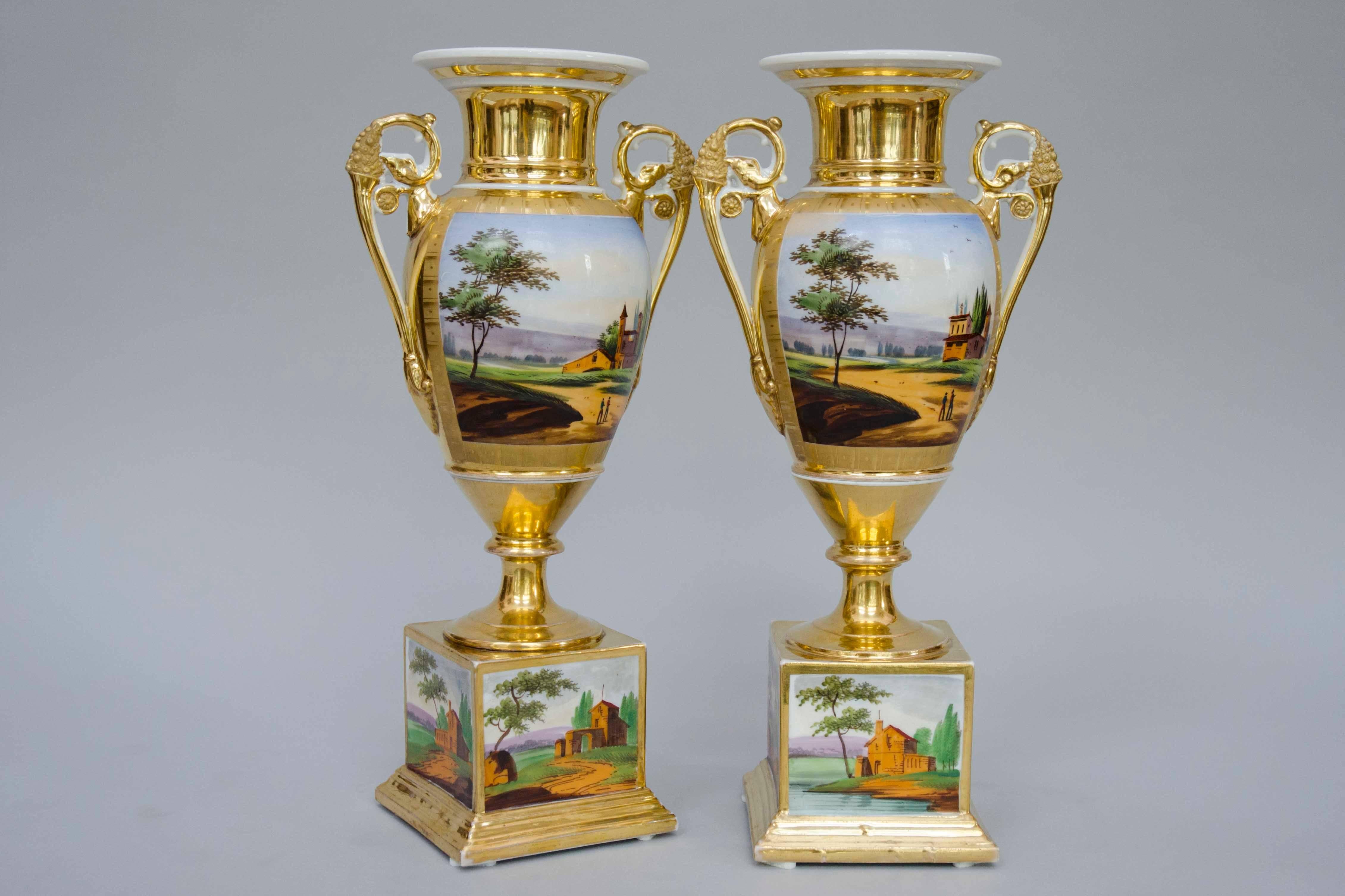 Lovely pair of very decorative and unusual 19th century vases in egg shape on square bases. Fruit baskets as handles. Nice gilding with no wear and nice painted landscapes. 
Size: H 36cm - square bases: 9cm x 9cm
Manufactory of XL, Brussels, circa