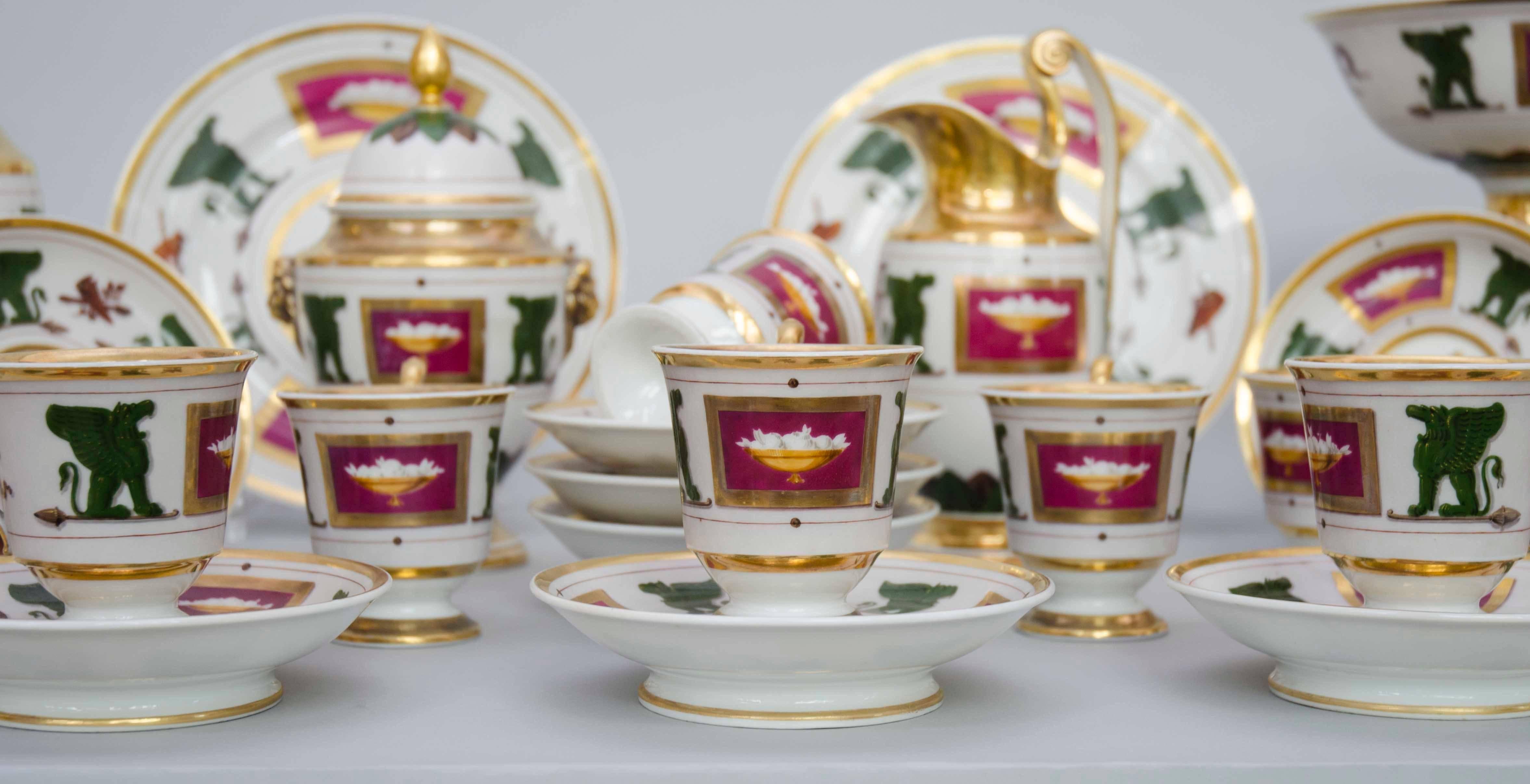Beautiful tea and coffee set with teapot, coffee pot, milk jug, sugar pot, cream bowl and an ensemble of ten cups and saucers and two large plates. Beautiful Empire decorations with fruit baskets and winged lions, in the French taste. Great