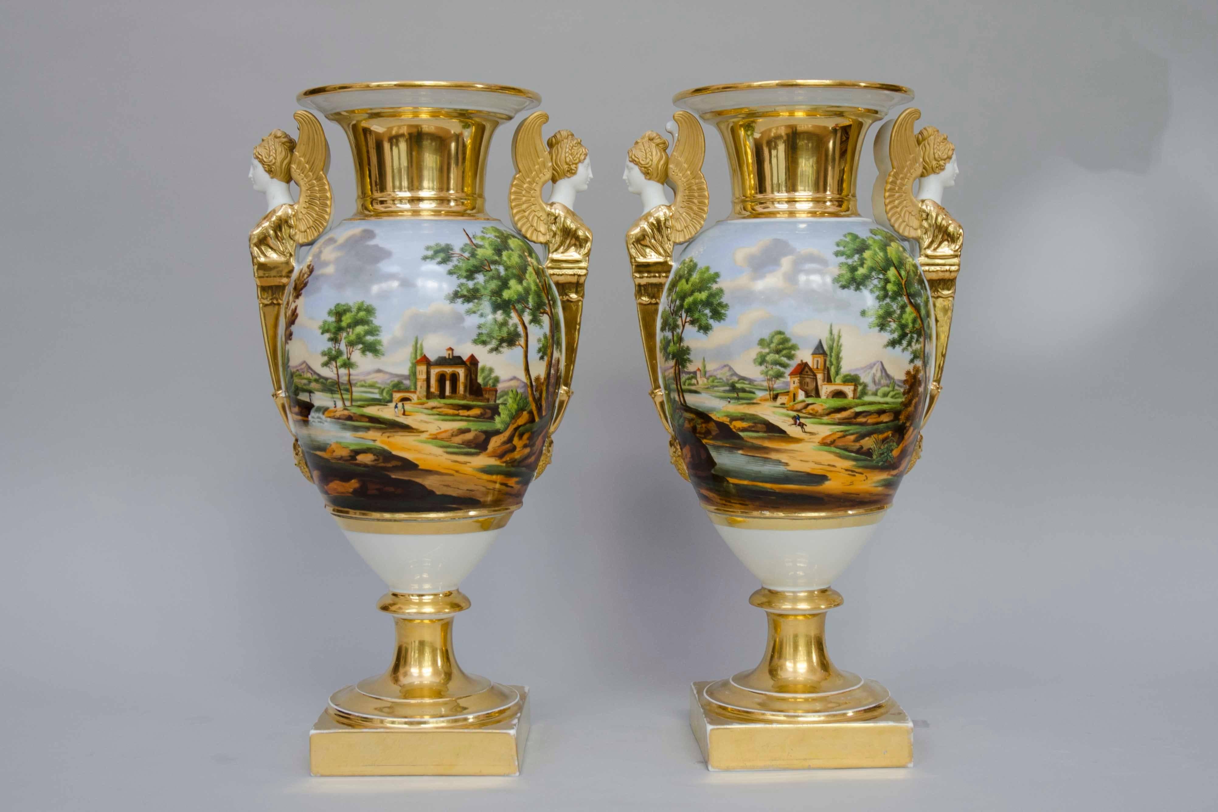 Large pair of very decorative 19th century egg shaped vases with Italian landscapes on the entire bodies of the vases. Busts of winged women in bisque, partly gilded as handles. Piedouches. Great condition. 
base: H 43cm x W 23 cm - Base: 13cm x