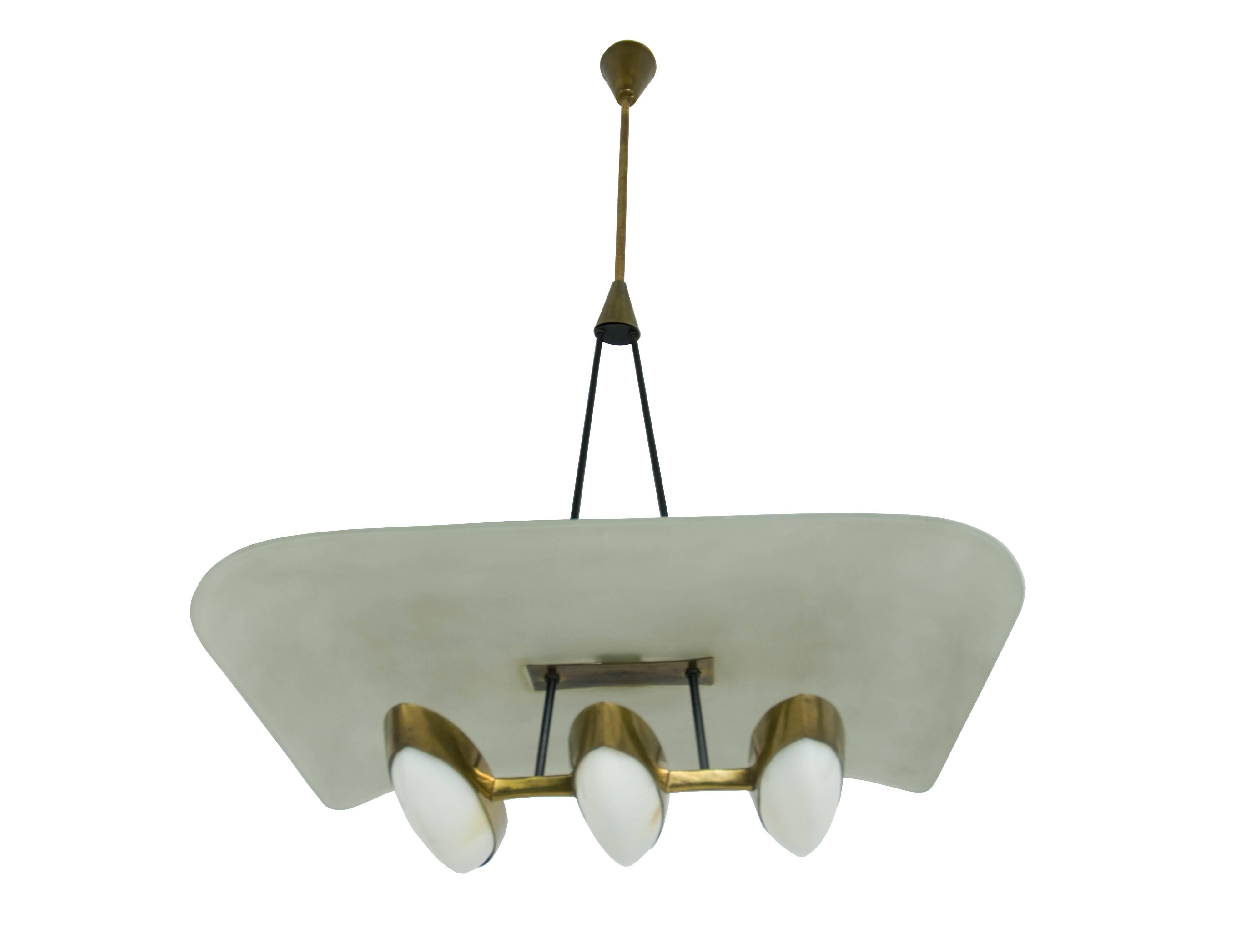 This three-light chandelier, attributed to Arredoluce production, was produced in Italy, circa 1950s. It is made from a brass and metal structure with three eye-shaped perspex bulb holders and a bent opaline glass shade. Overall good vintage