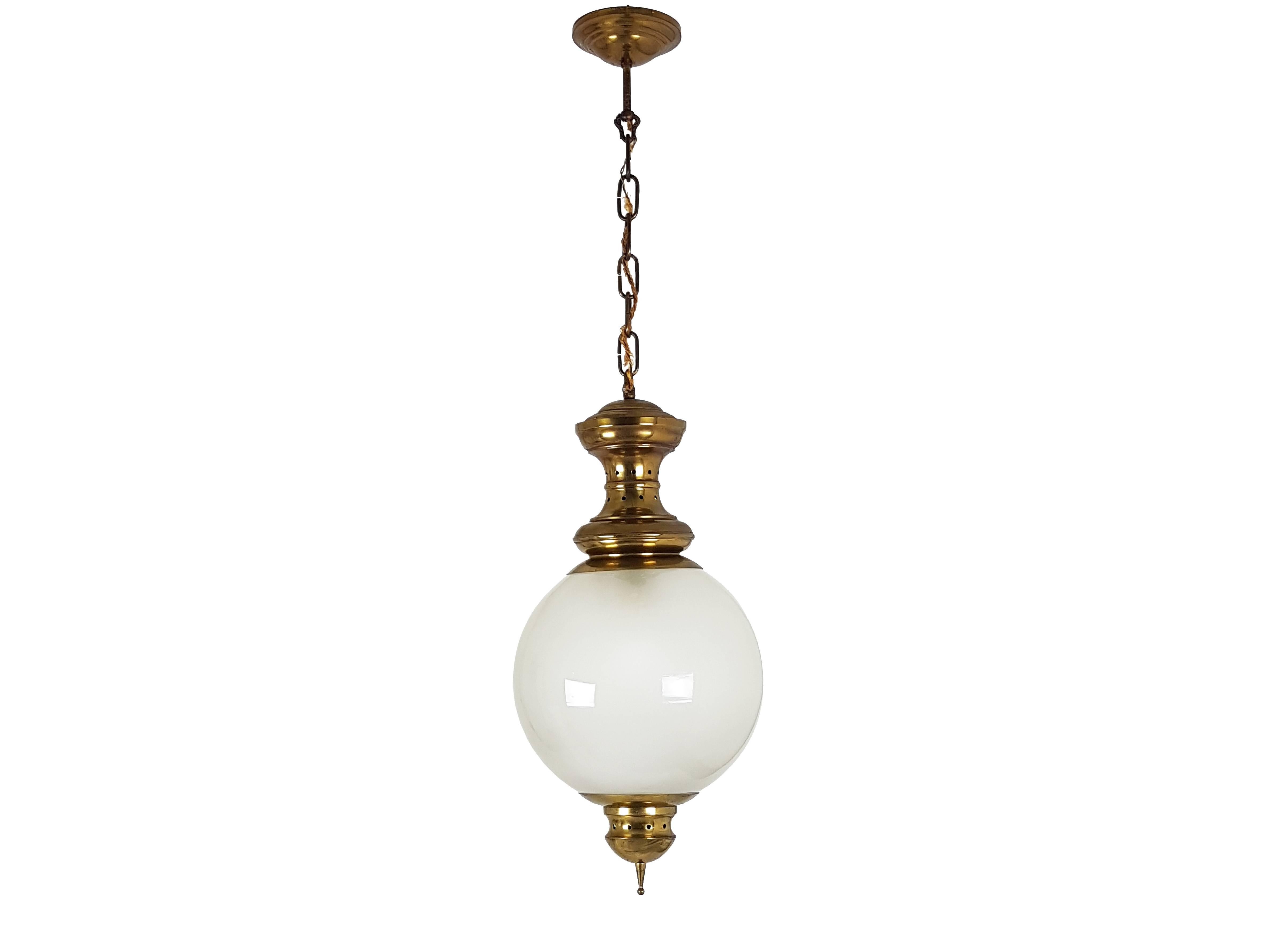 This elegant pendant is a classic Italian Azucena model. It is made from a brass frame and a spherical sandblasted glass shade. Very good vintage condition.