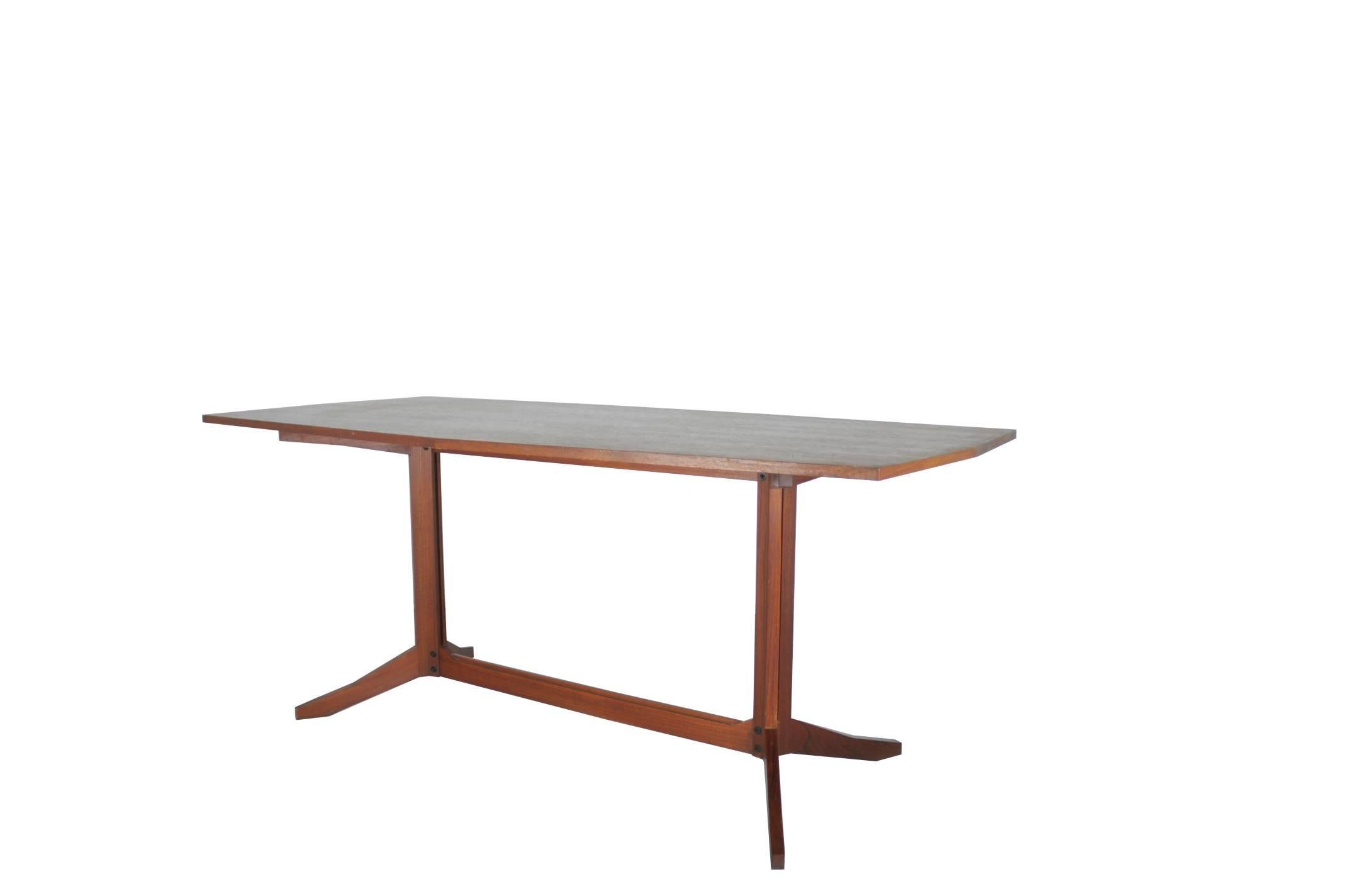 A beautiful teak table manufactured by Roberto Poggi and attributed to Franco Albini. It remains in a very good vintage condition: signs of wear and use as showed in pictures.