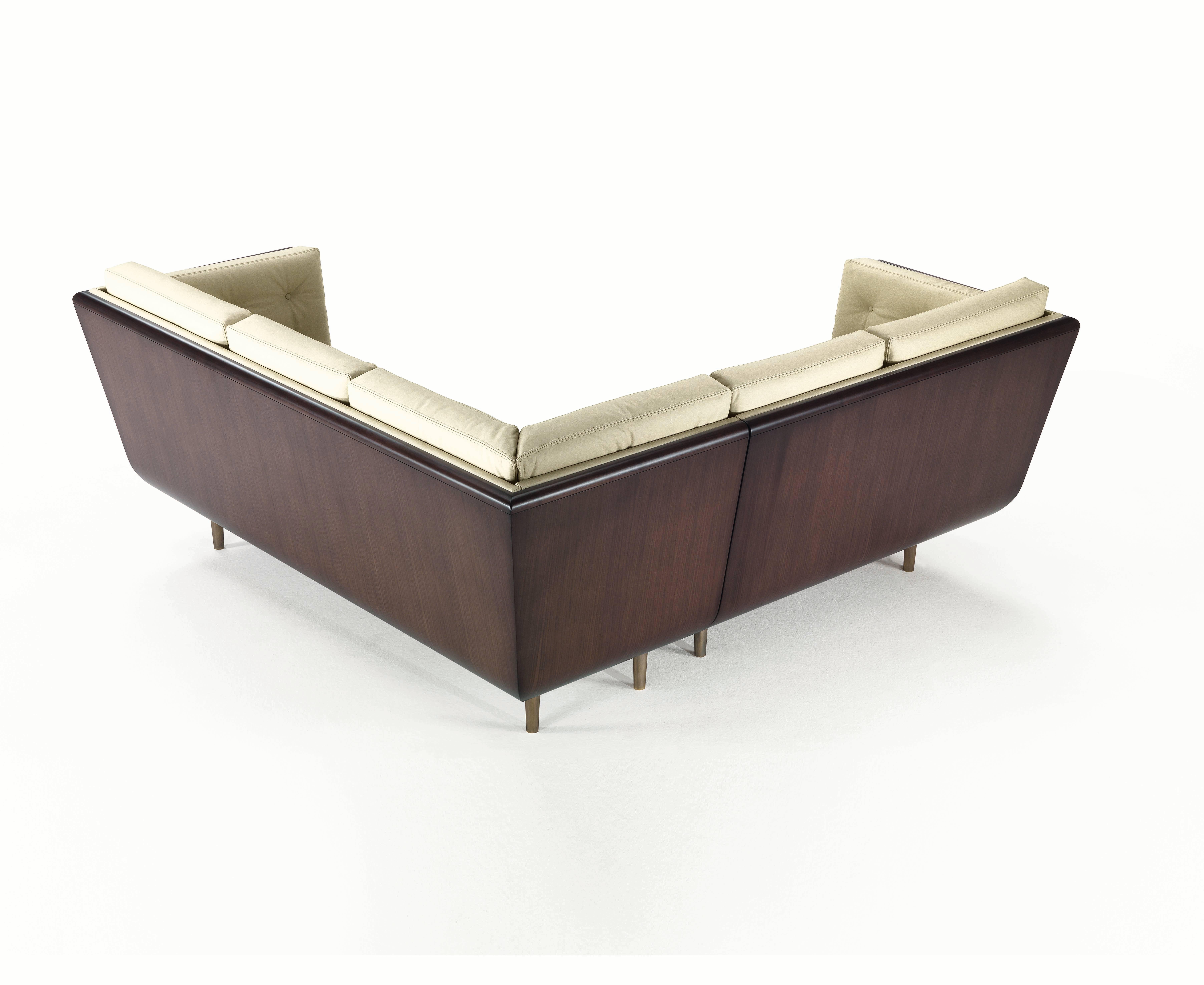 L-sofa in black American walnut stained dark brown in matte finish, seat and back cushion with buttoned detail, padded with expanded polyurethane and Dacron, upholstered with Nuvola Camelia leather, nr. 6 seats. Bronze tapered feet.