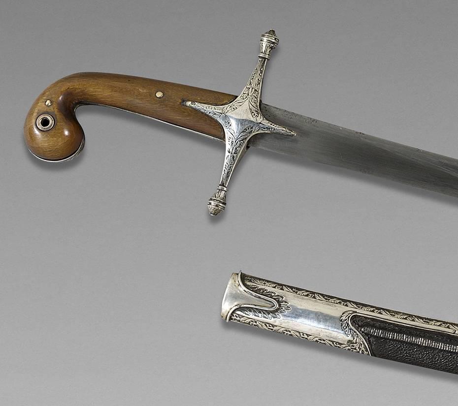 Oriental Saber, also called Shamshir
Ottoman Empire, late 18th century

Handle in horn, silver mounted, damascus blade, scabbard garnished of black leather.

Measures: Whole saber: 40 1/2 wide 
Blade: 40 1/2