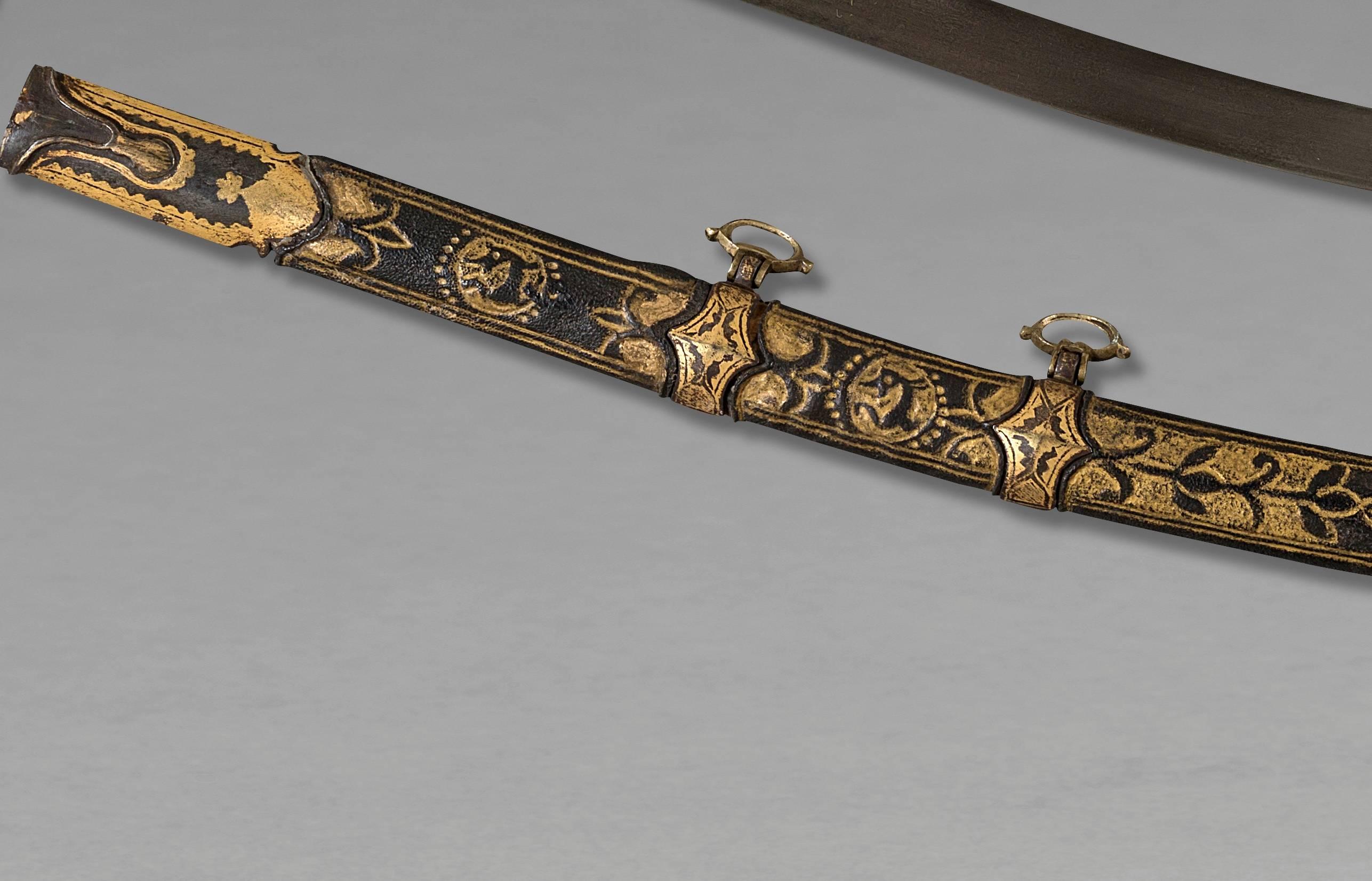 Oriental Saber, called Shamshir 
Ottoman Empire, late 18th century 

Handle in horn, steel mounted, Damascus blade, scabbard garnished of black leather with gold floral motif incrustations.

Whole saber: 40 1/5