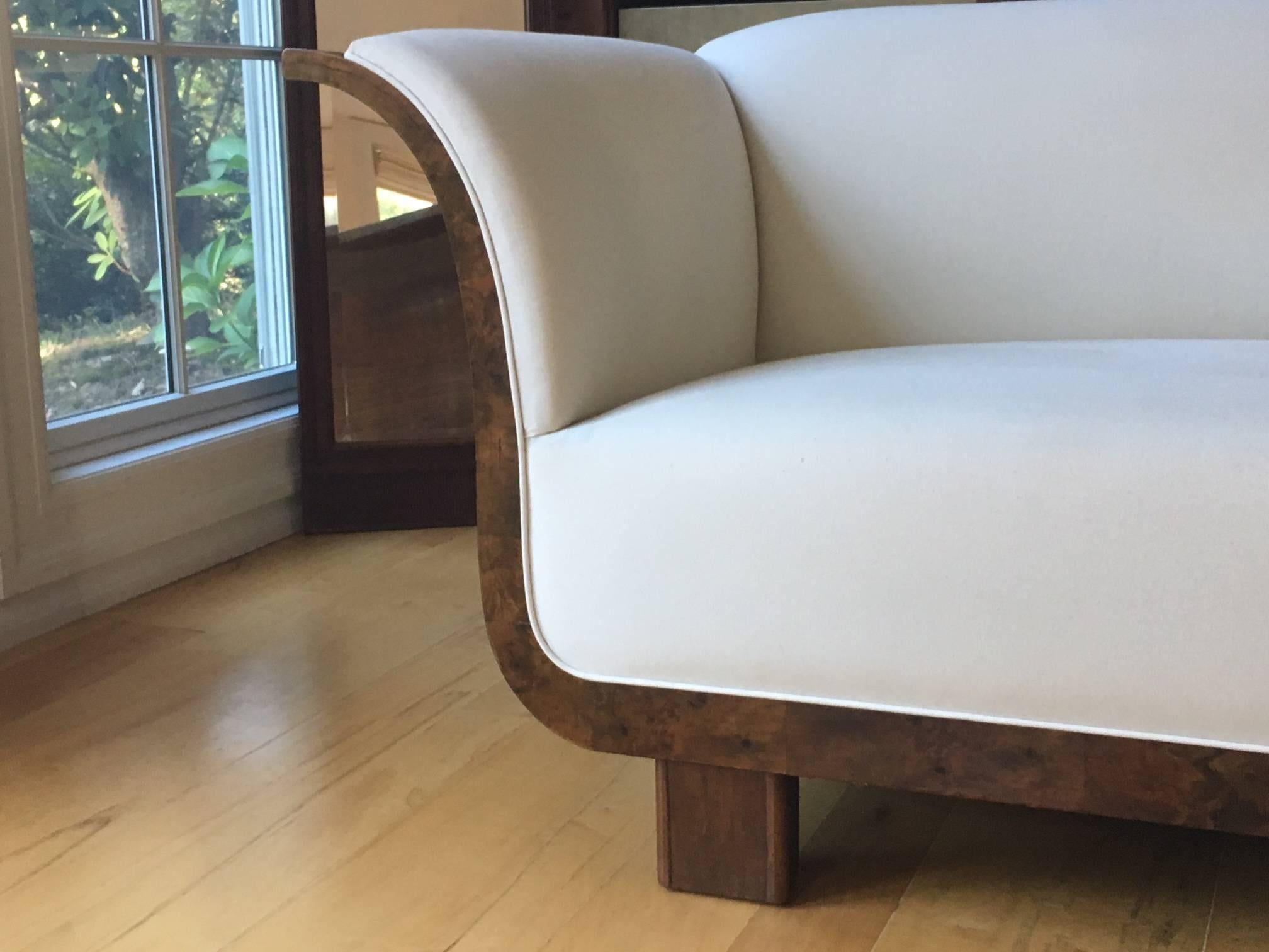 Stunning Danish Art Deco sofa. Burled and French walnut, circa 1930.

This beautifully designed sofa, with its fabulous curves, was originally meant for installation directly against a wall with an unfinished back. We wished to honor the original