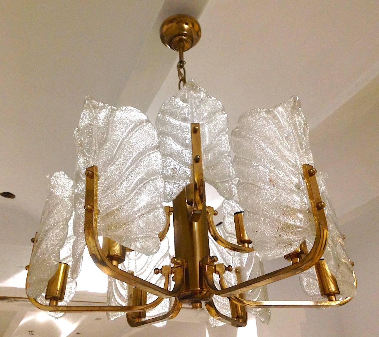 A wonderful, elegant glass chandelier by Carl Fagerlund for Orrefors, Sweden, circa 1960s. It is composed of nine textured Barovier & Toso Murano glass leaves and a six-light brass frame.