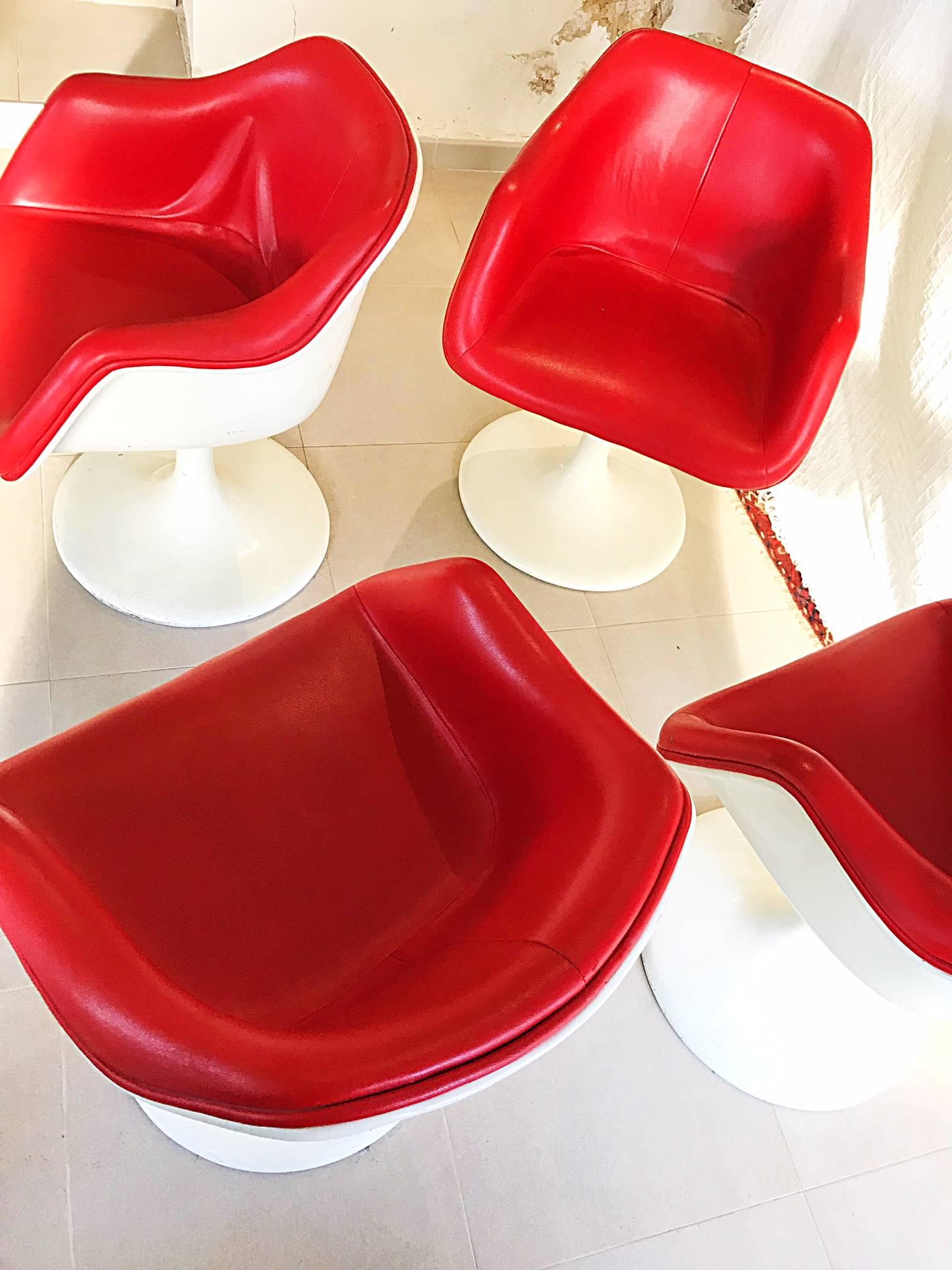 Eero Saarinen Style four fiberglass tulip armchairs faux leather

Four armchairs identical tulip chairs, structurally sound. 
Original warm white finish.
Red original faux leather complete seat in good condition! 
We have in stock 17 pieces! we sell