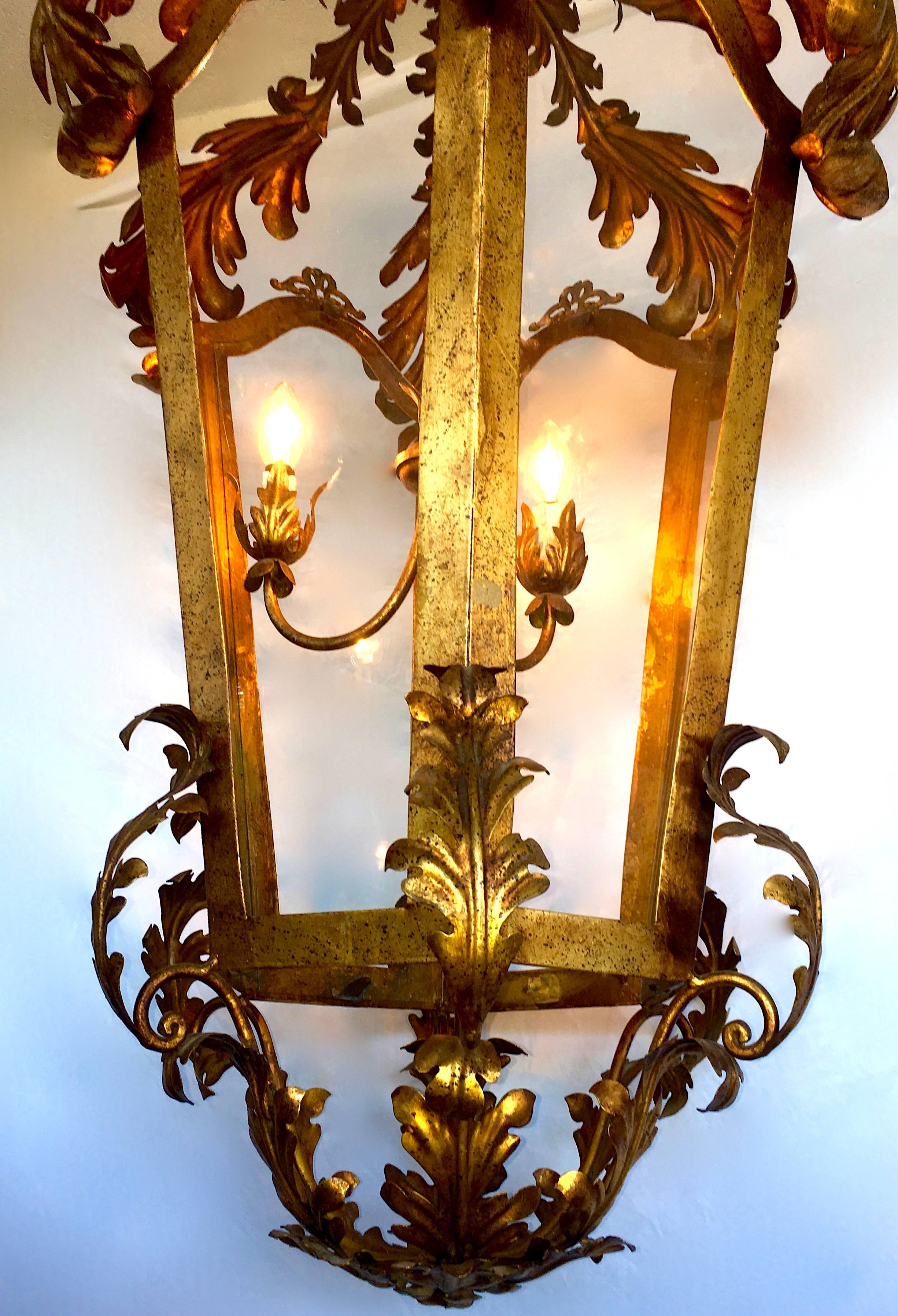 Large glass lanterns with applied leaves.
Three-side lantern, patinated gold metal decorated with cut metal leaves. Venetian Italian work dating from the beginning of 20 century. Measure: 140 cm height.
A real stunning ORIGINAL vintage period lamp