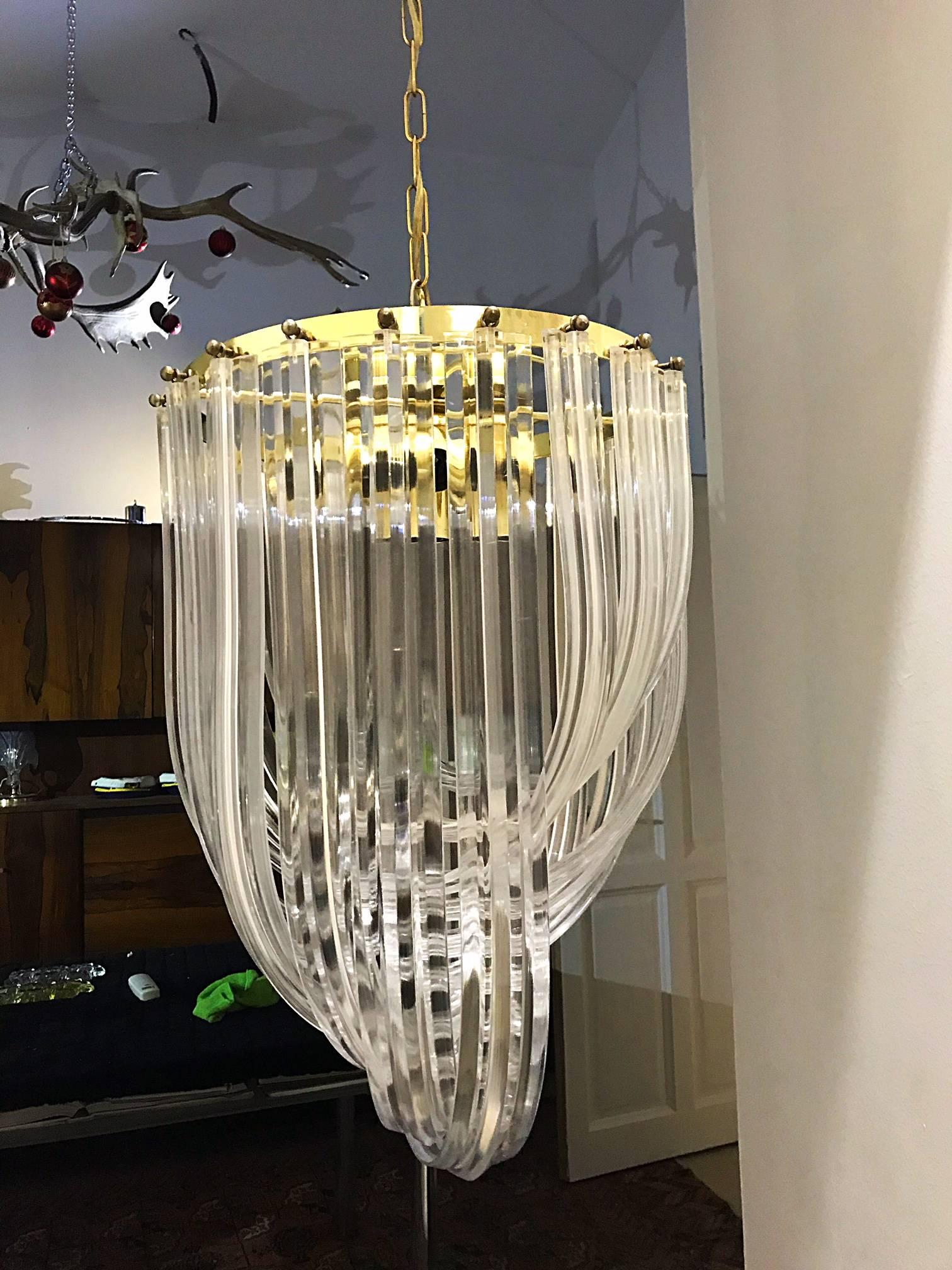 Carlo Nason model Interlocking layers of molded Lucite loops; gold round metal structure. Can hand as chandelier from matching chain or as a flush mounted fixture. Cultivates unexpected and exceptional lighting, furniture and design. Measures: 130
