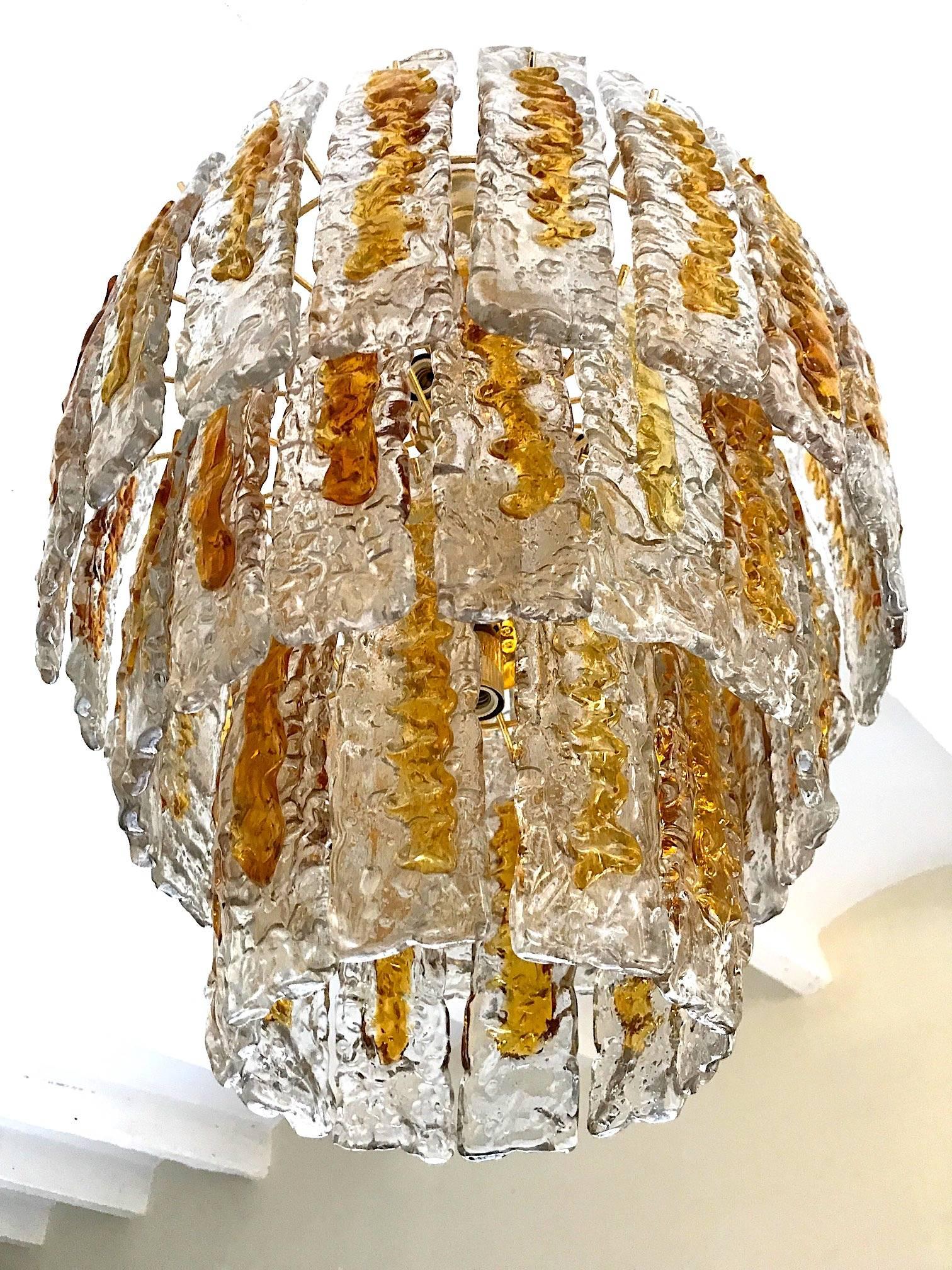 Italian Mid-Century Modern amber colored glass chandelier handblown in Murano by Mazzega. 
A real stunning ORIGINAL vintage period lamp !! Model made in hand-made by the greatest glassmakers (all offers are studied) to add the international shipping