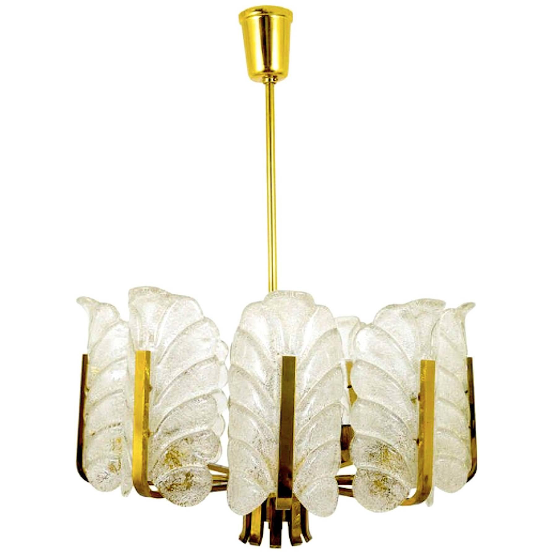 A wonderful, elegant glass chandelier by Carl Fagerlund for Orrefors, Sweden, circa 1960s. It is composed of 7 textured Barovier & Toso Murano glass leaves and a 7-light brass frame.
A real stunning ORIGINAL vintage period lamp !! Model made in