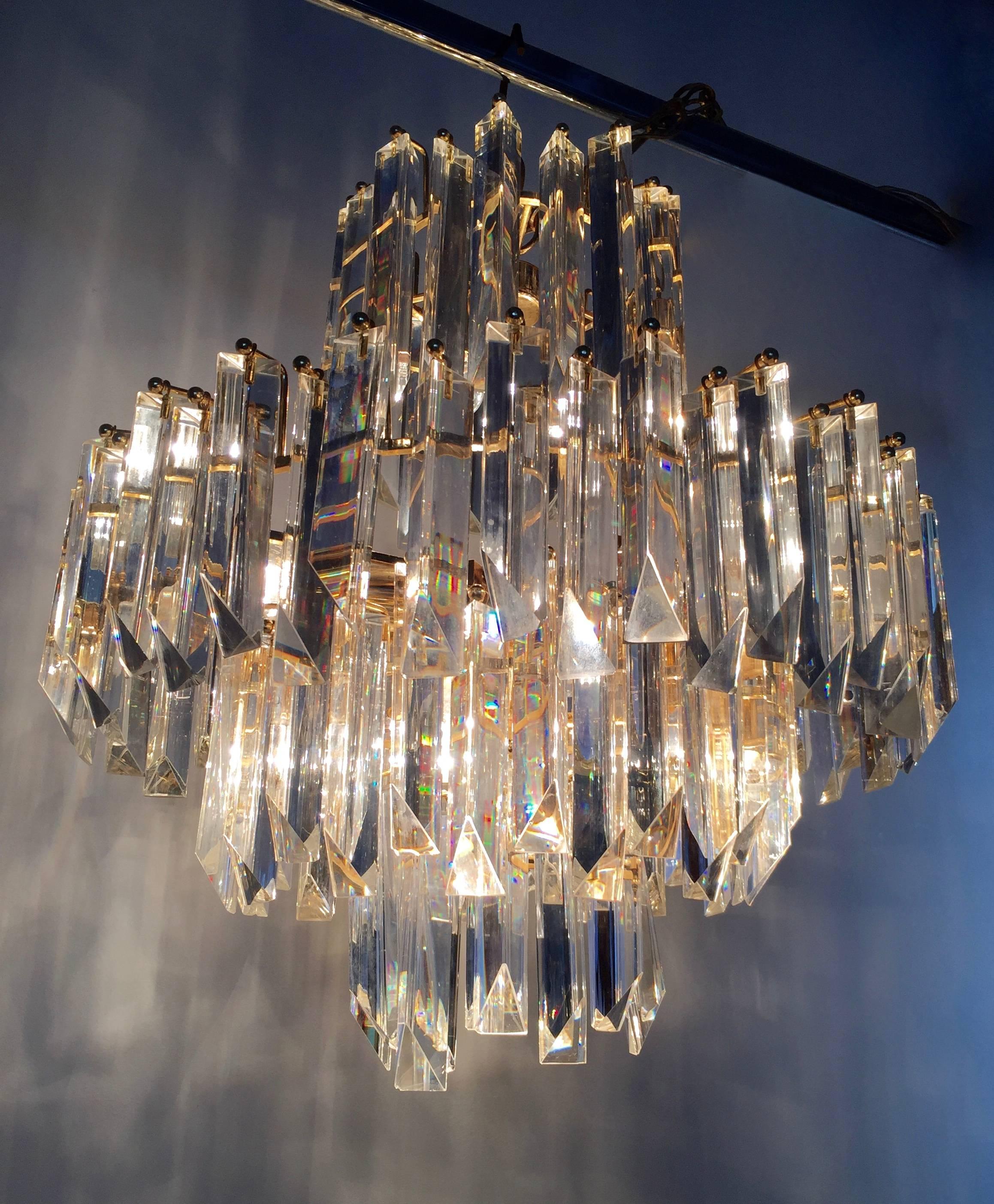 Italian Mid-Century Modern chandelier by Venini which has multi-tier cascading prisms. Consisting of clear crystals, circa 1960. Any amount of chain can be added for custom hanging length of the chandelier.