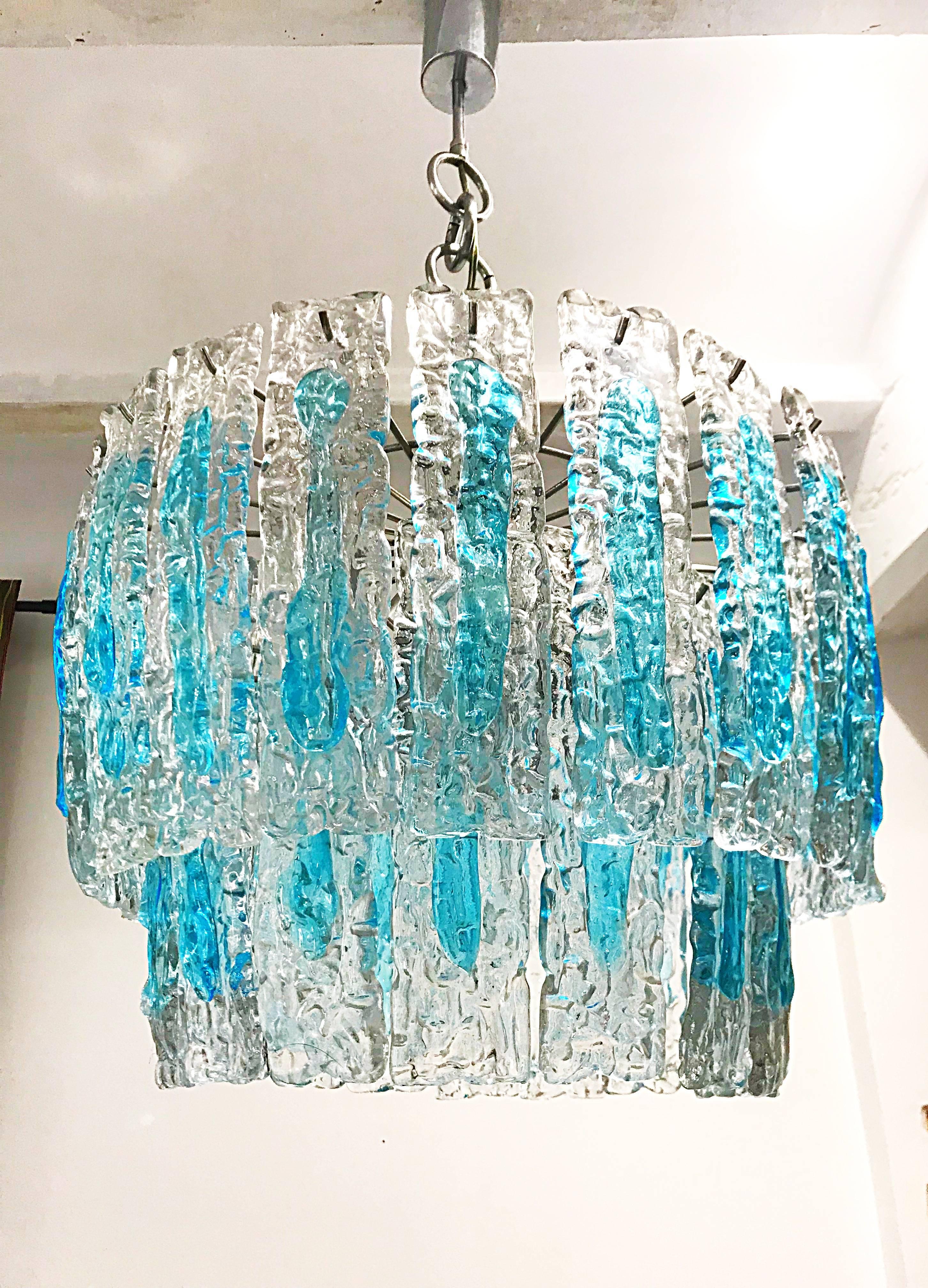 Italian Mid-Century Modern Blue colored glass chandelier handblown in Murano by Mazzega. This Piece has a double layer of glass and imparts a warm light. The inner layer has ten pieces and the outer layer has a long pieces with both forming an